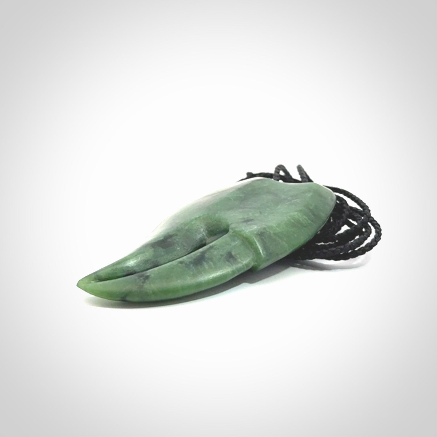 This large crab claw pendant is carved from a lovely deep green piece of New Zealand jade. It has an adjustable black coloured cord which can be slipped over the head and adjusted to the length that you prefer. Hand carved in New Zealand from our local jade by Kyohei Noguchi.