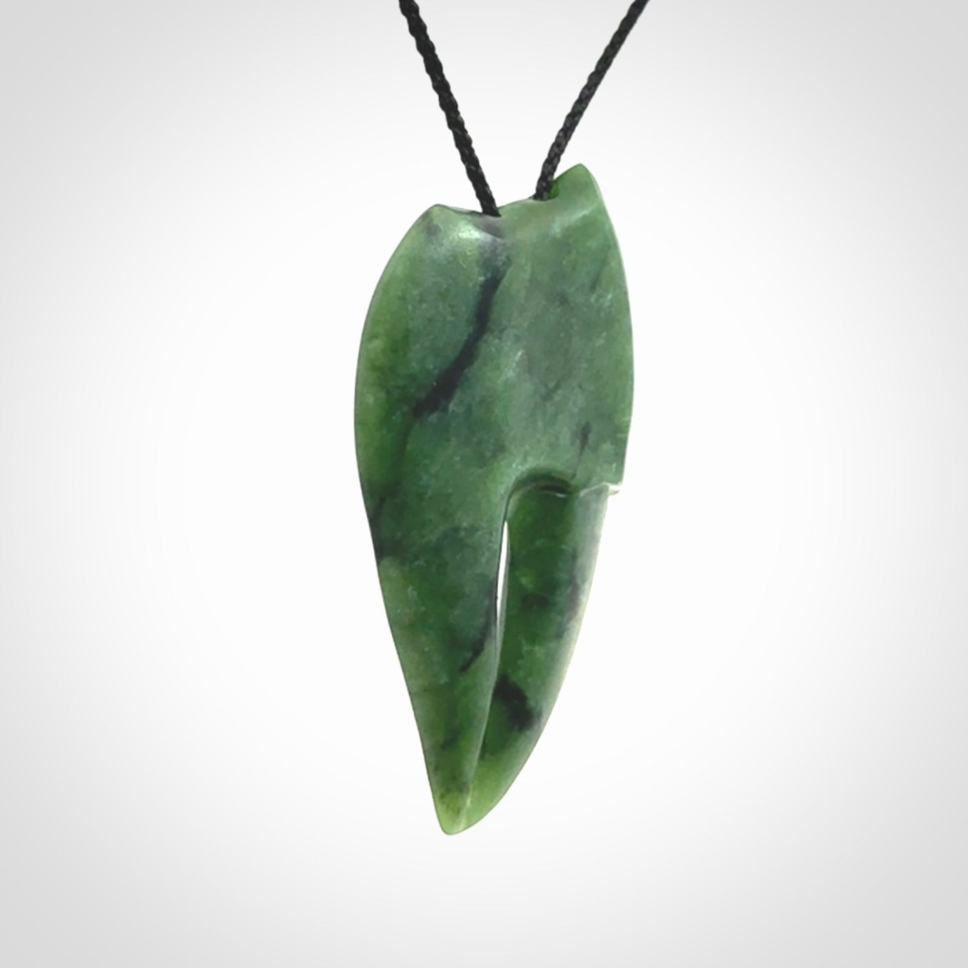 This large crab claw pendant is carved from a lovely deep green piece of New Zealand jade. It has an adjustable black coloured cord which can be slipped over the head and adjusted to the length that you prefer. Hand carved in New Zealand from our local jade by Kyohei Noguchi.