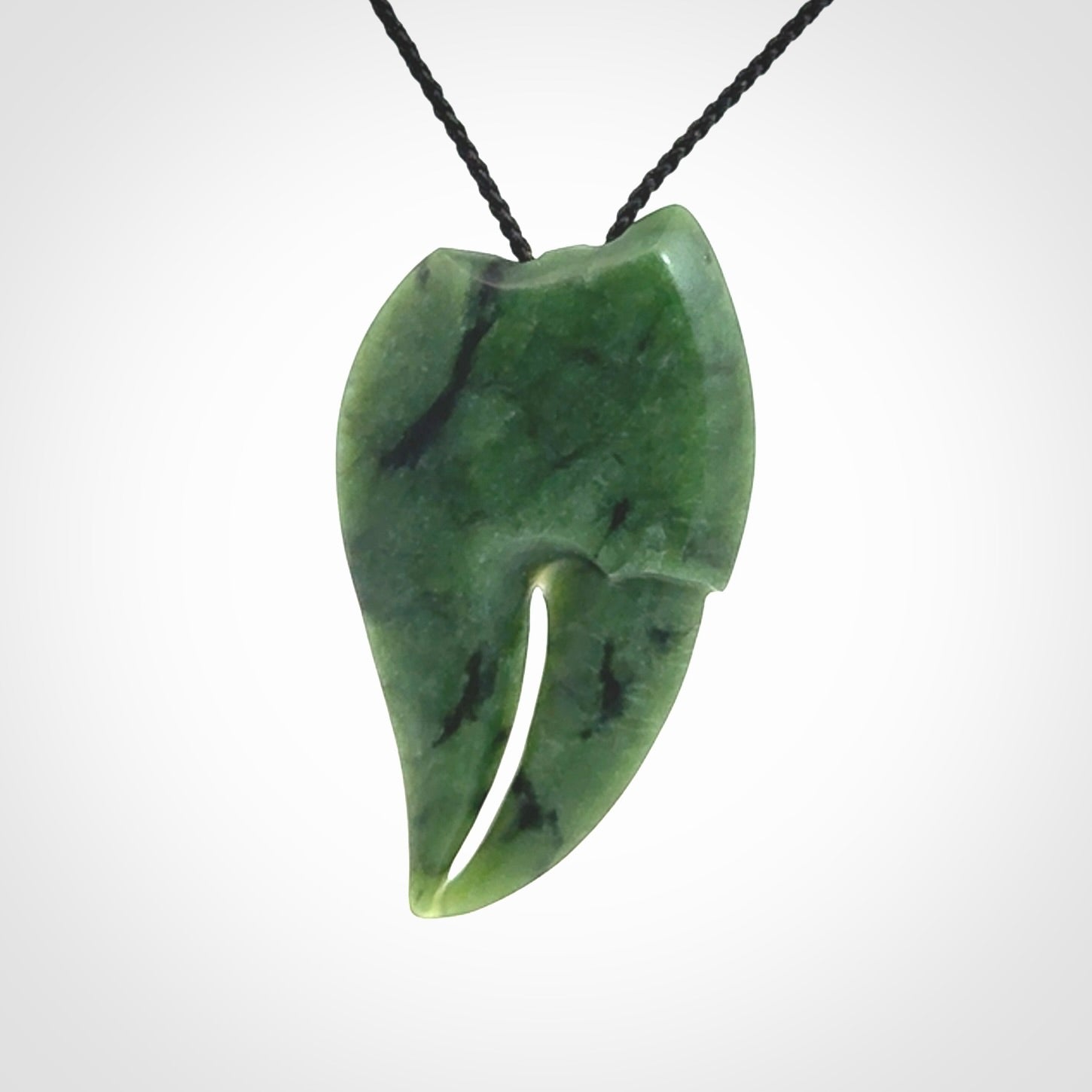 This large crab claw pendant is carved from a lovely deep green piece of New Zealand jade. It has an adjustable black coloured cord which can be slipped over the head and adjusted to the length that you prefer. Hand carved in New Zealand from our local jade by Kyohei Noguchi.