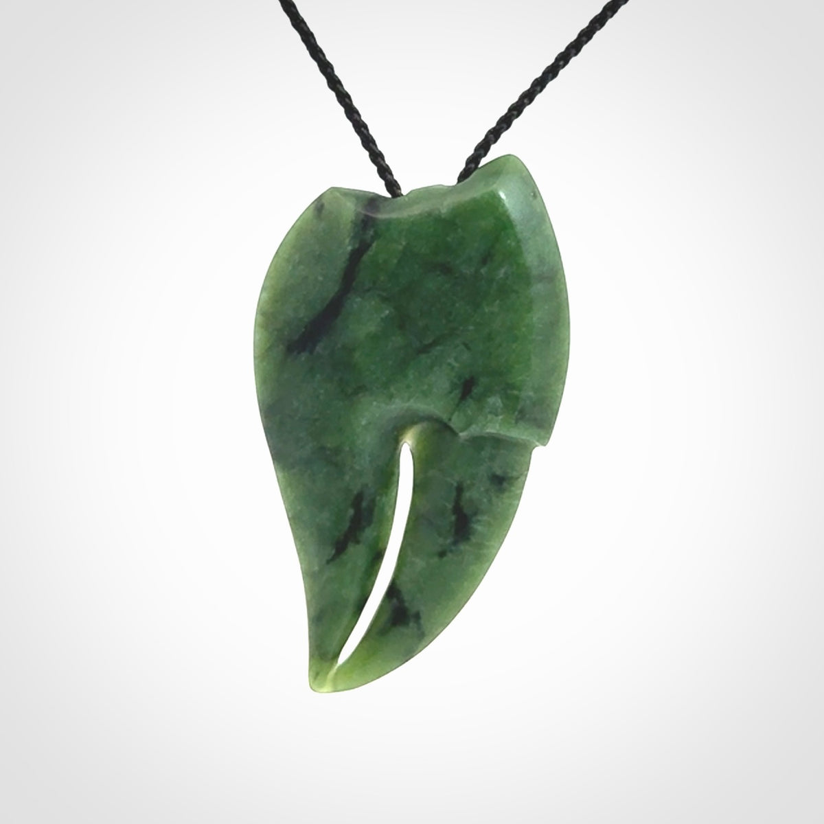This large crab claw pendant is carved from a lovely deep green piece of New Zealand jade. It has an adjustable black coloured cord which can be slipped over the head and adjusted to the length that you prefer. Hand carved in New Zealand from our local jade by Kyohei Noguchi.