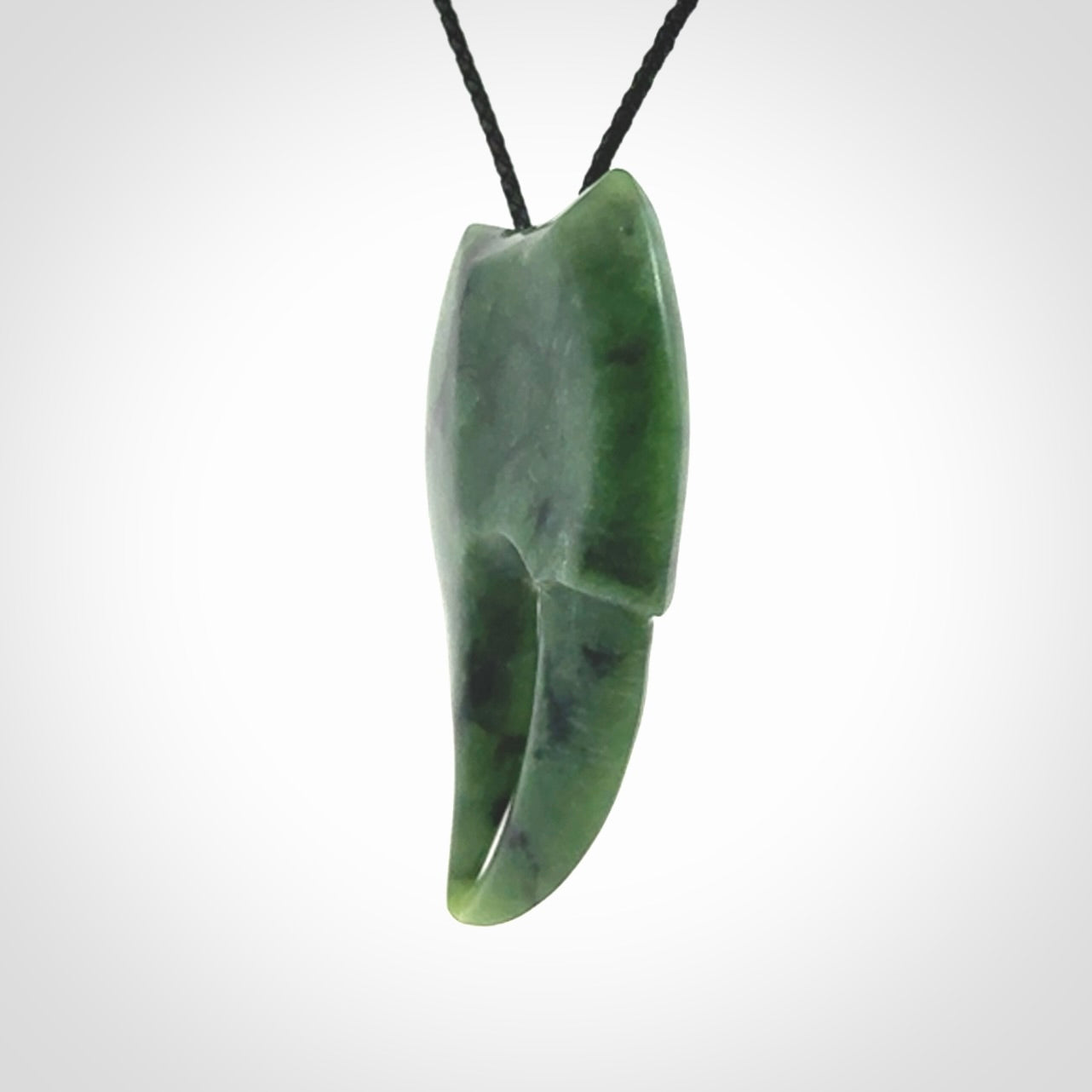 This large crab claw pendant is carved from a lovely deep green piece of New Zealand jade. It has an adjustable black coloured cord which can be slipped over the head and adjusted to the length that you prefer. Hand carved in New Zealand from our local jade by Kyohei Noguchi.