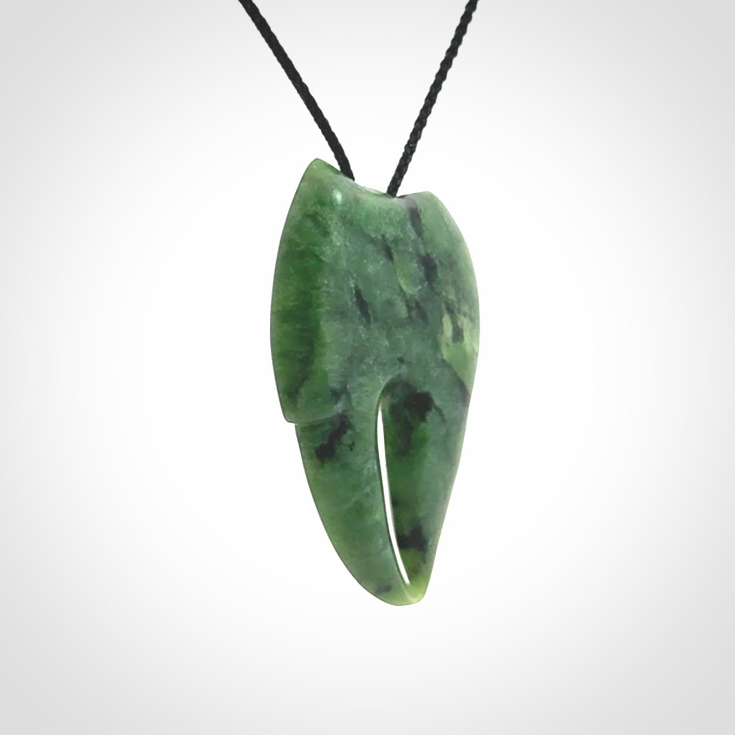 This large crab claw pendant is carved from a lovely deep green piece of New Zealand jade. It has an adjustable black coloured cord which can be slipped over the head and adjusted to the length that you prefer. Hand carved in New Zealand from our local jade by Kyohei Noguchi.