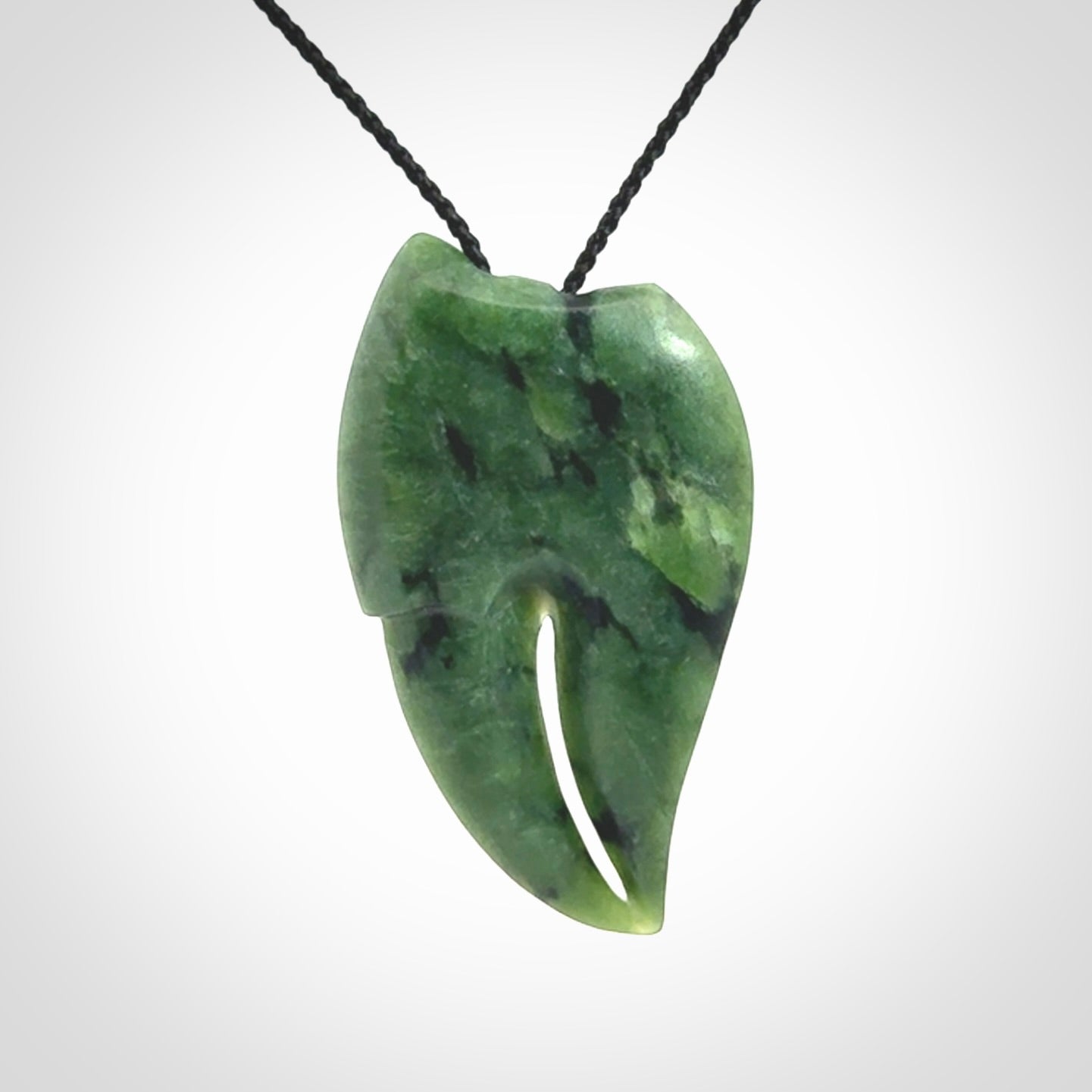 This large crab claw pendant is carved from a lovely deep green piece of New Zealand jade. It has an adjustable black coloured cord which can be slipped over the head and adjusted to the length that you prefer. Hand carved in New Zealand from our local jade by Kyohei Noguchi.