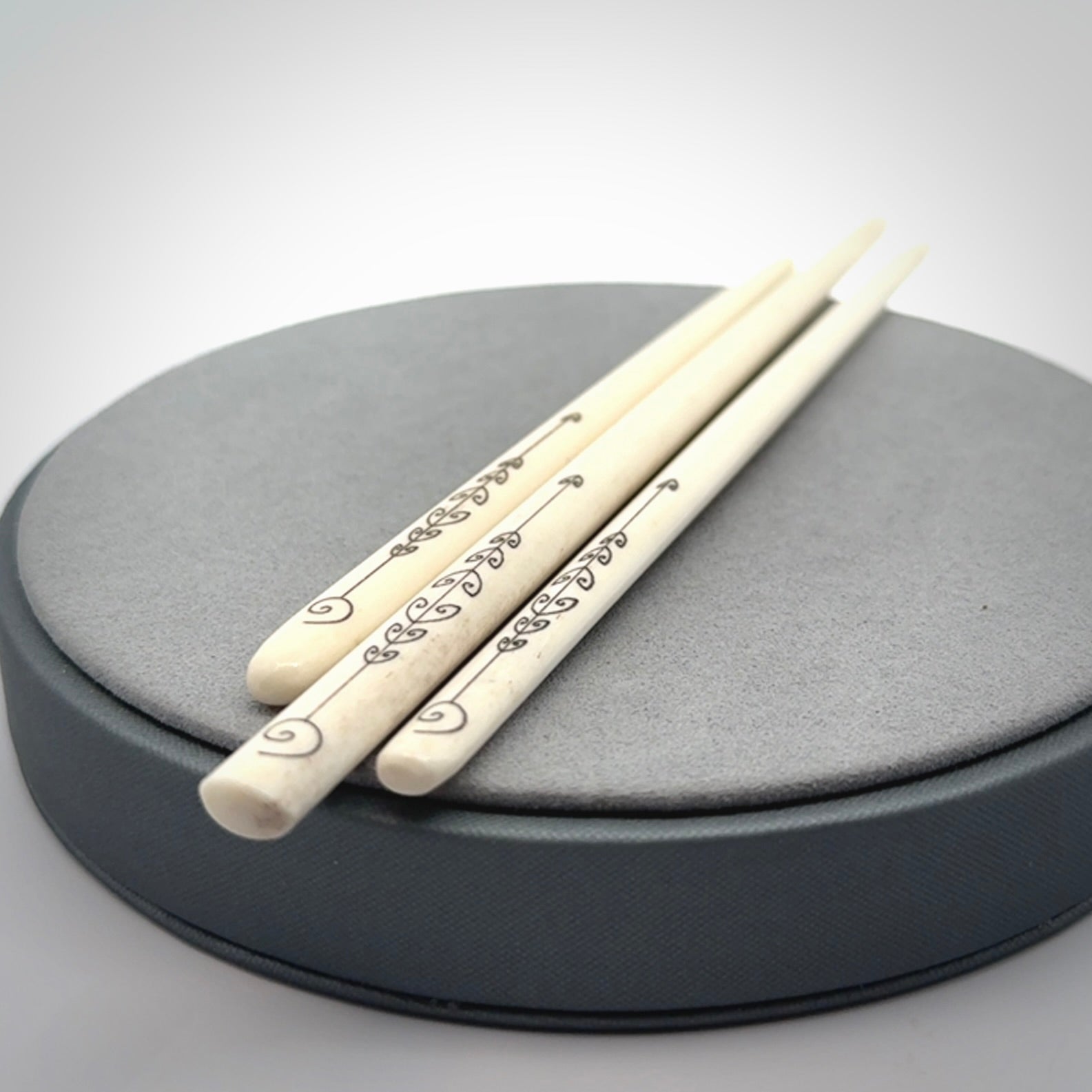 Hand carved bone hair pin with double sided koru design.