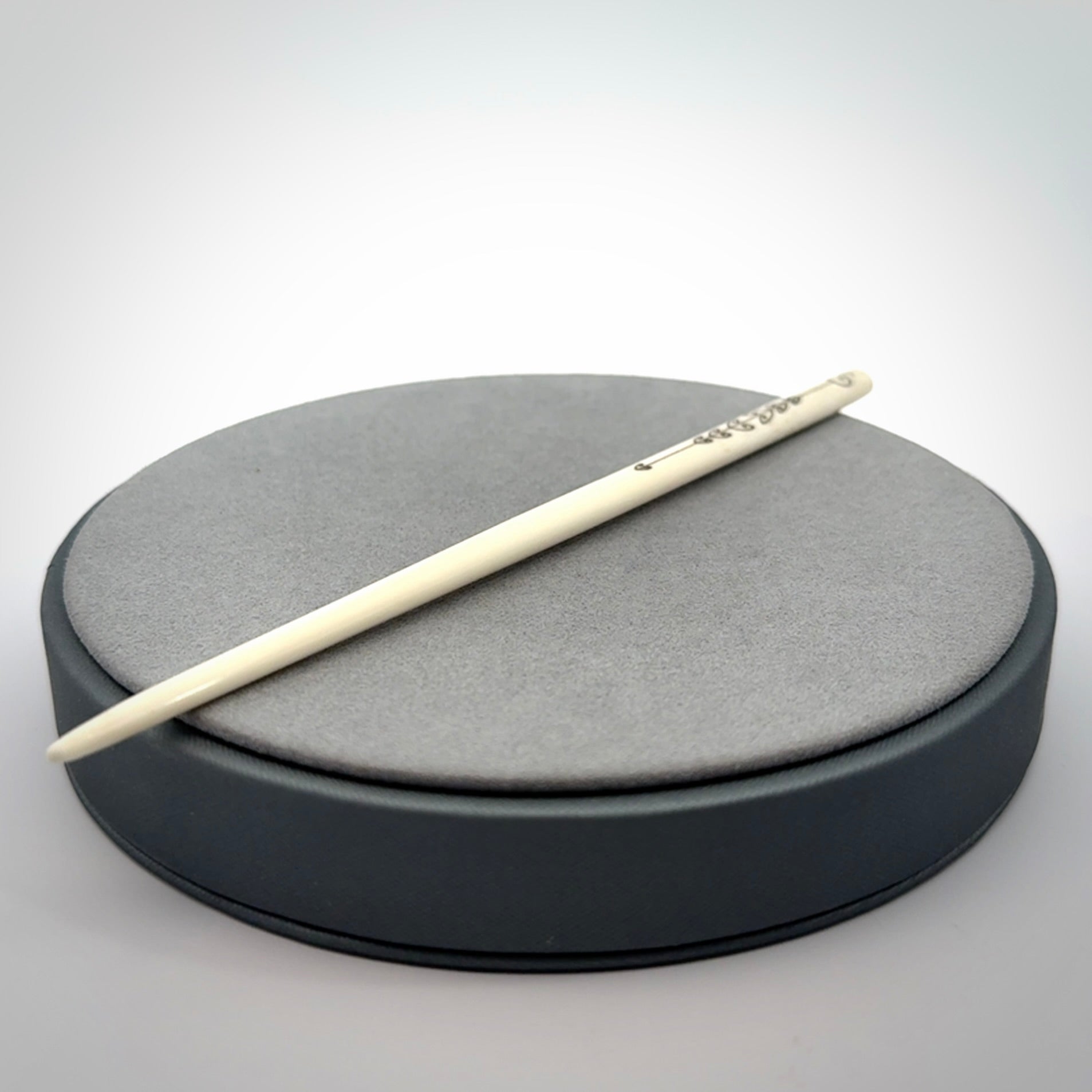 Hand carved bone hair pin with double sided koru design.