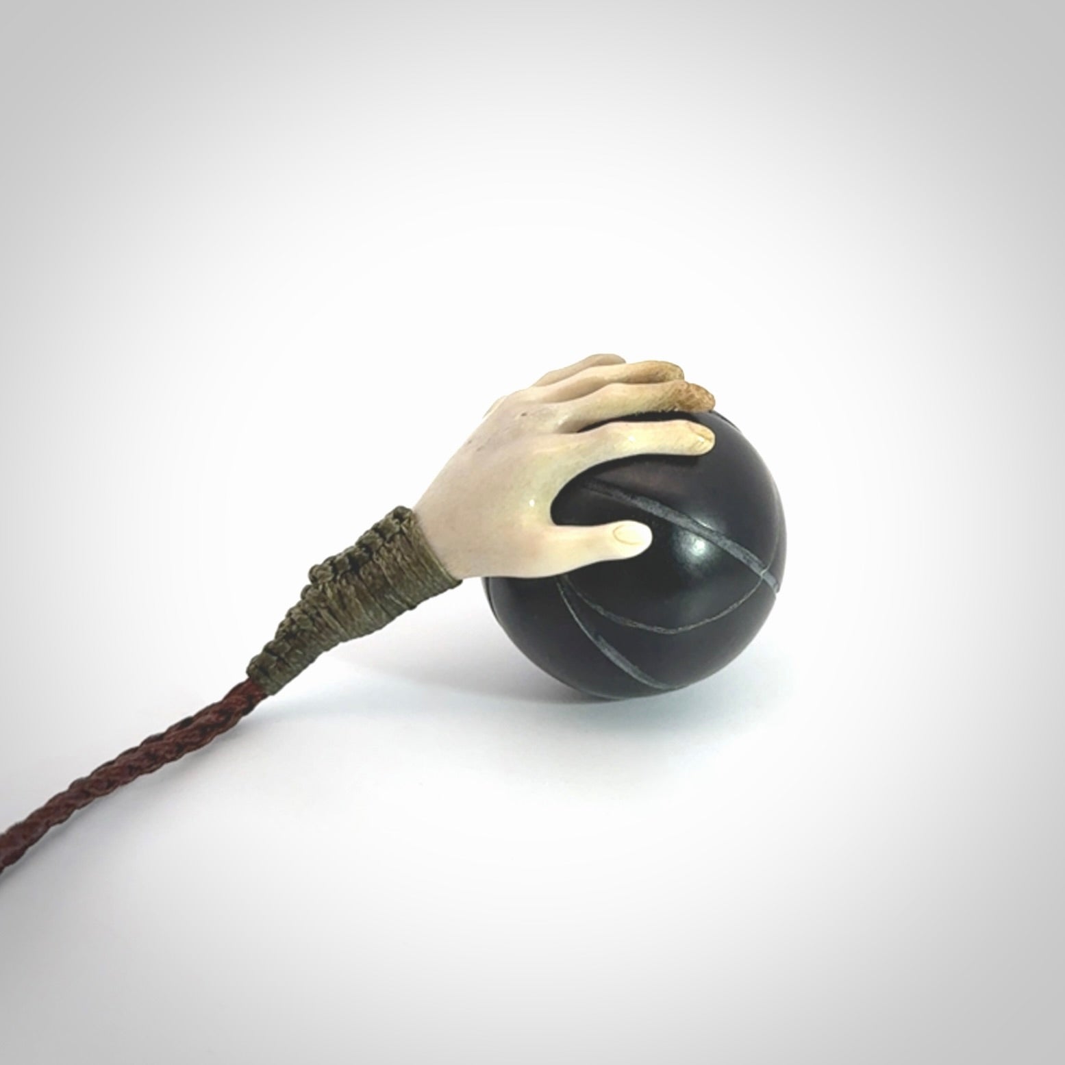 This is a very cool pendant that we've had carved for all you Basketball fans. The DUNK is a pendant with a deer antler hand holding a black jade basketball. We provide this on an adjustable cord, and we ship worldwide. A very cool pendant, different, edgy and very wearable.