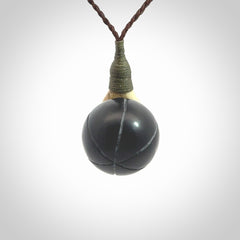 This is a very cool pendant that we've had carved for all you Basketball fans. The DUNK is a pendant with a deer antler hand holding a black jade basketball. We provide this on an adjustable cord, and we ship worldwide. A very cool pendant, different, edgy and very wearable.