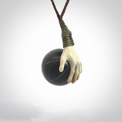 This is a very cool pendant that we've had carved for all you Basketball fans. The DUNK is a pendant with a deer antler hand holding a black jade basketball. We provide this on an adjustable cord, and we ship worldwide. A very cool pendant, different, edgy and very wearable.