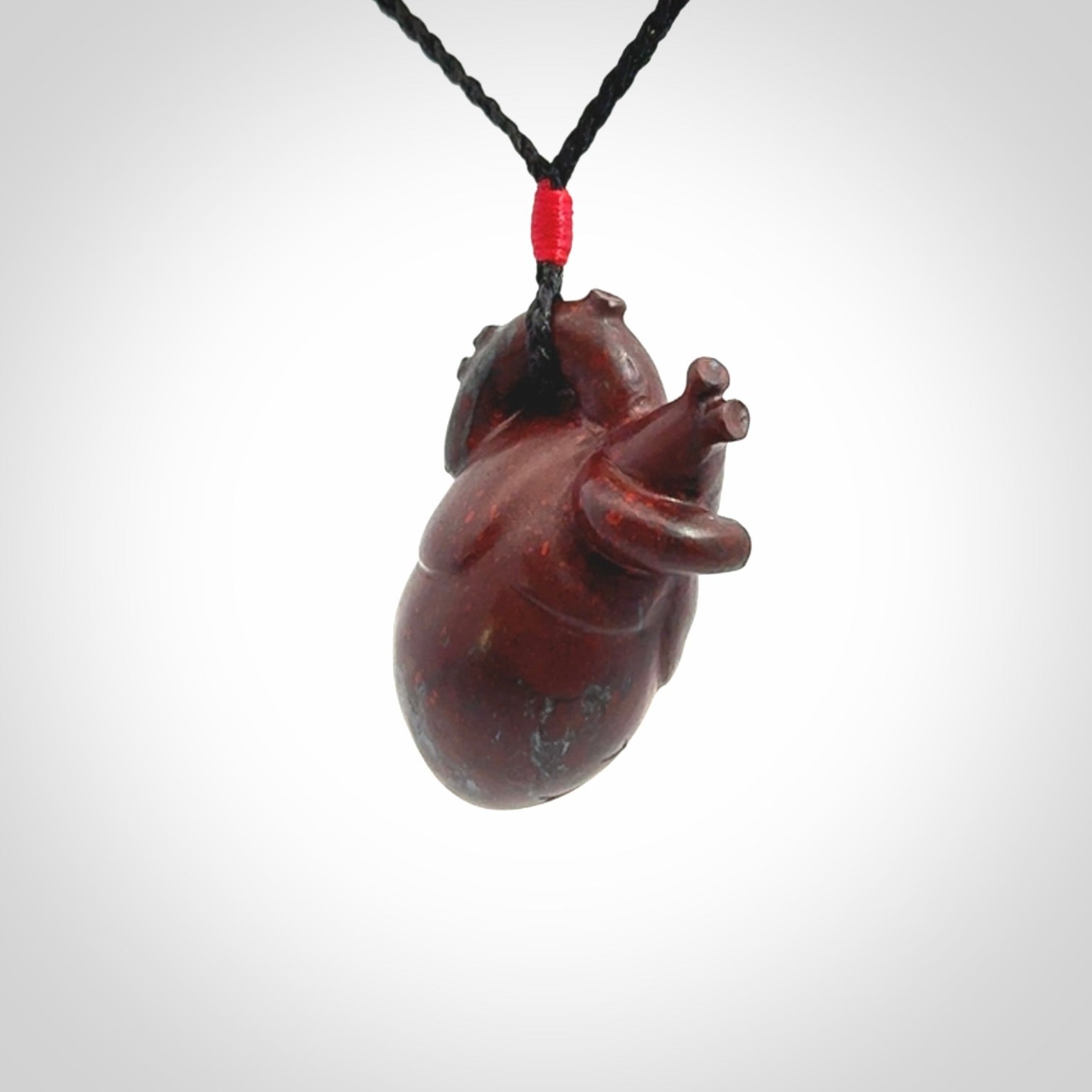 This pendant is handcrafted from Red Jasper Stone. It replicates a human heart. It is supplied with an adjustable black cord.