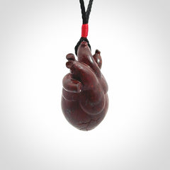 This pendant is handcrafted from Red Jasper Stone. It replicates a human heart. It is supplied with an adjustable black cord.