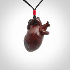 This pendant is handcrafted from Red Jasper Stone. It replicates a human heart. It is supplied with an adjustable black cord.