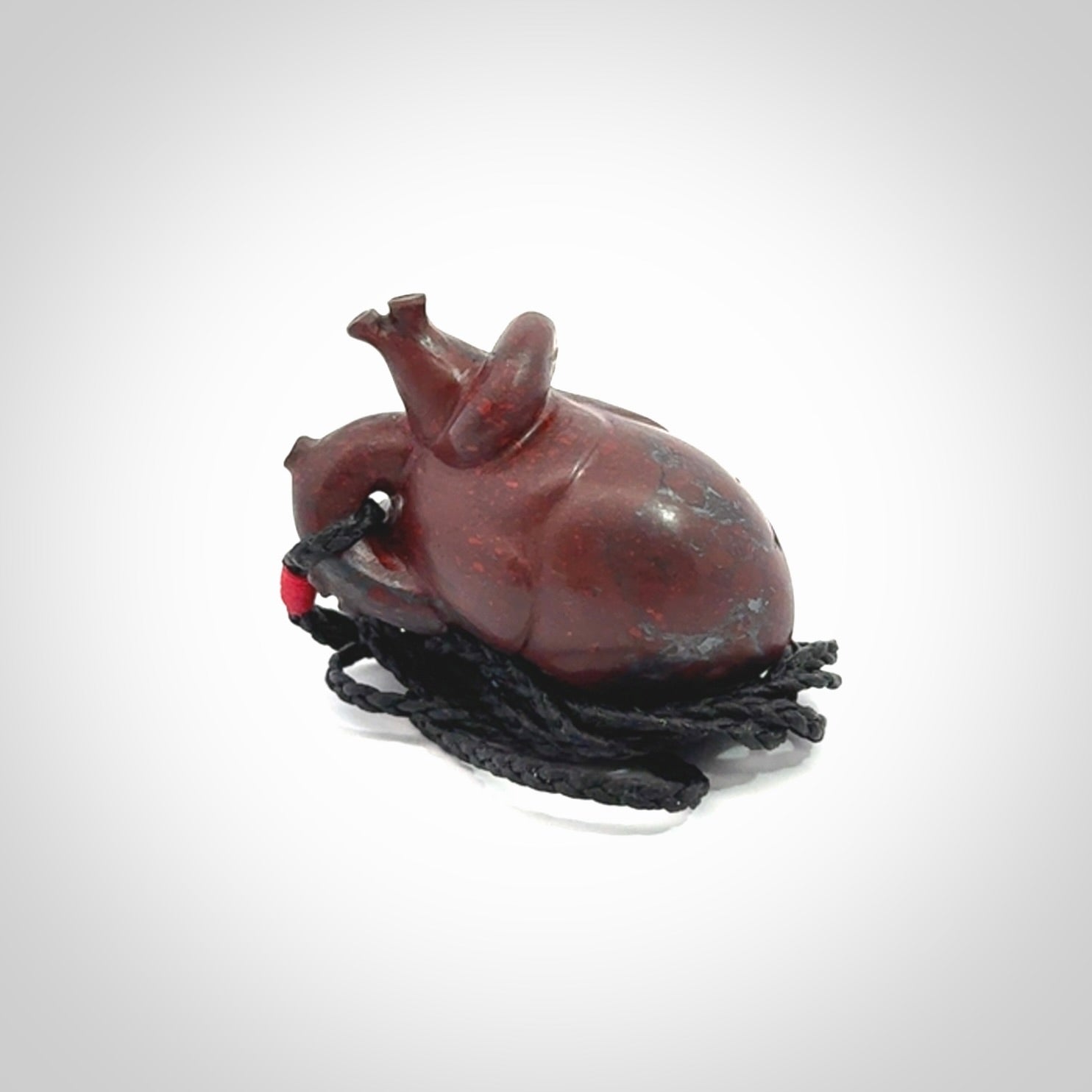 This pendant is handcrafted from Red Jasper Stone. It replicates a human heart. It is supplied with an adjustable black cord.