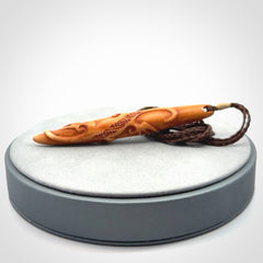 Bone carving of a lizard climbing. A three dimensional pendant carved in bone by Yuri Terenyi.