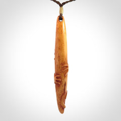 Bone carving of a lizard climbing. A three dimensional pendant carved in bone by Yuri Terenyi.