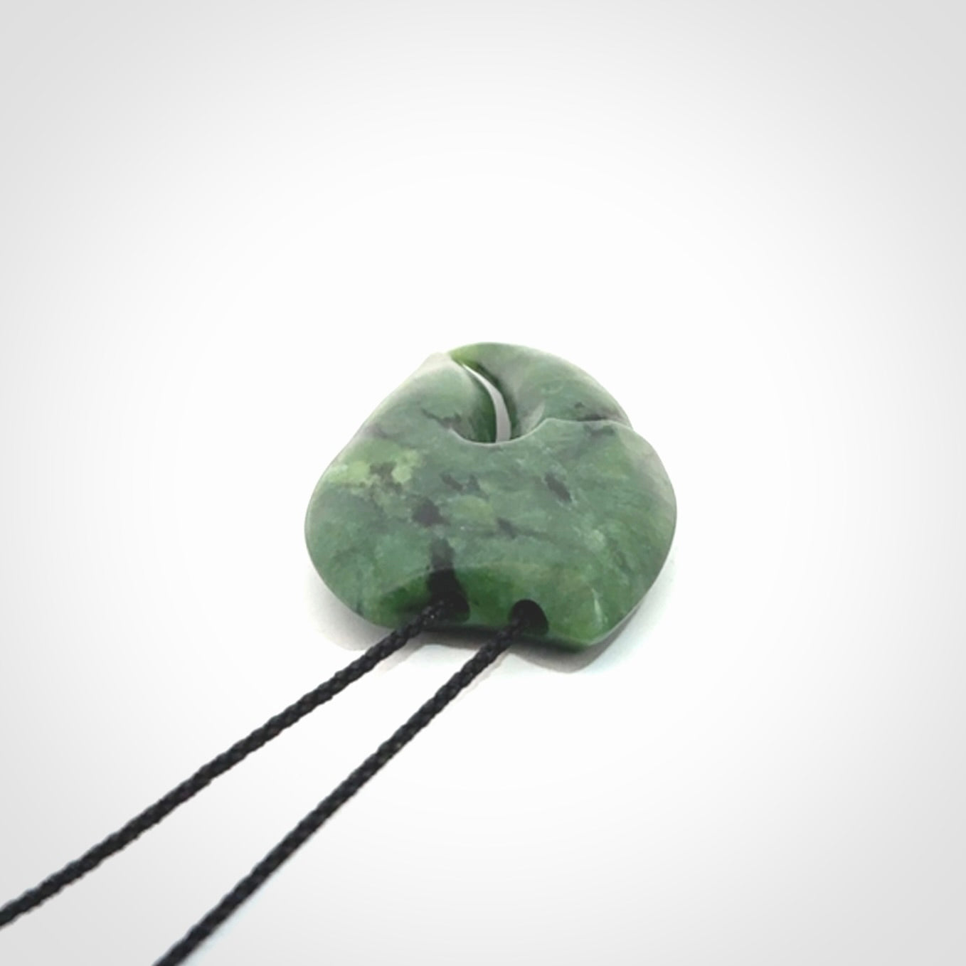 This large crab claw pendant is carved from a lovely deep green piece of New Zealand jade. It has an adjustable black coloured cord which can be slipped over the head and adjusted to the length that you prefer. Hand carved in New Zealand from our local jade by Kyohei Noguchi.