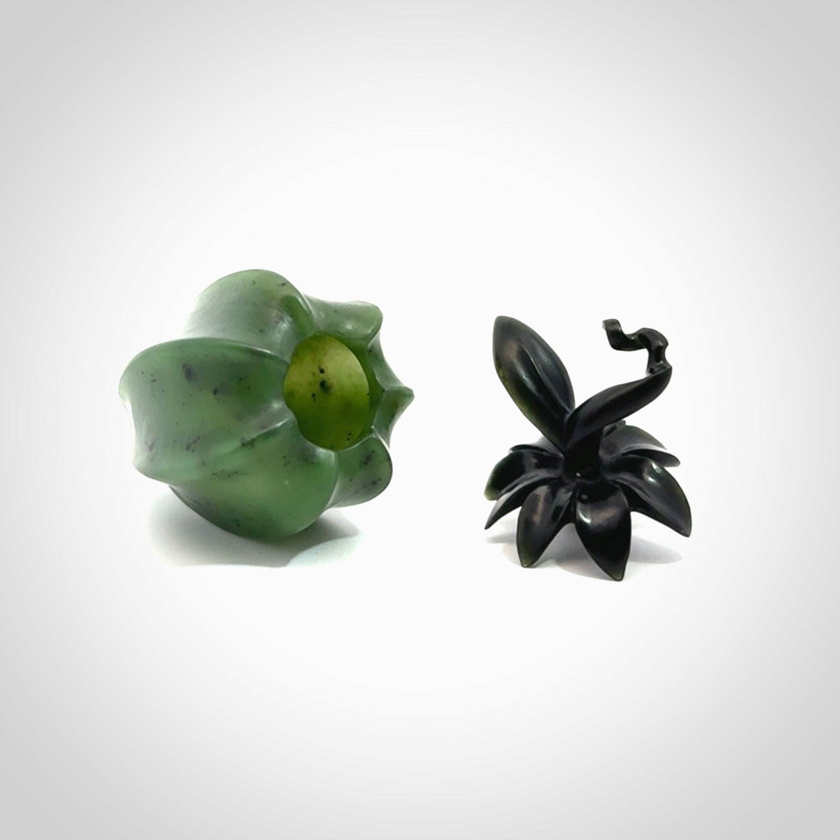 Hand carved Gooseberry sculpture crafted in Black Jade, British Columbian Jade with Basalt stone stand. One only Gooseberry sculpture with lid that encloses a bell.