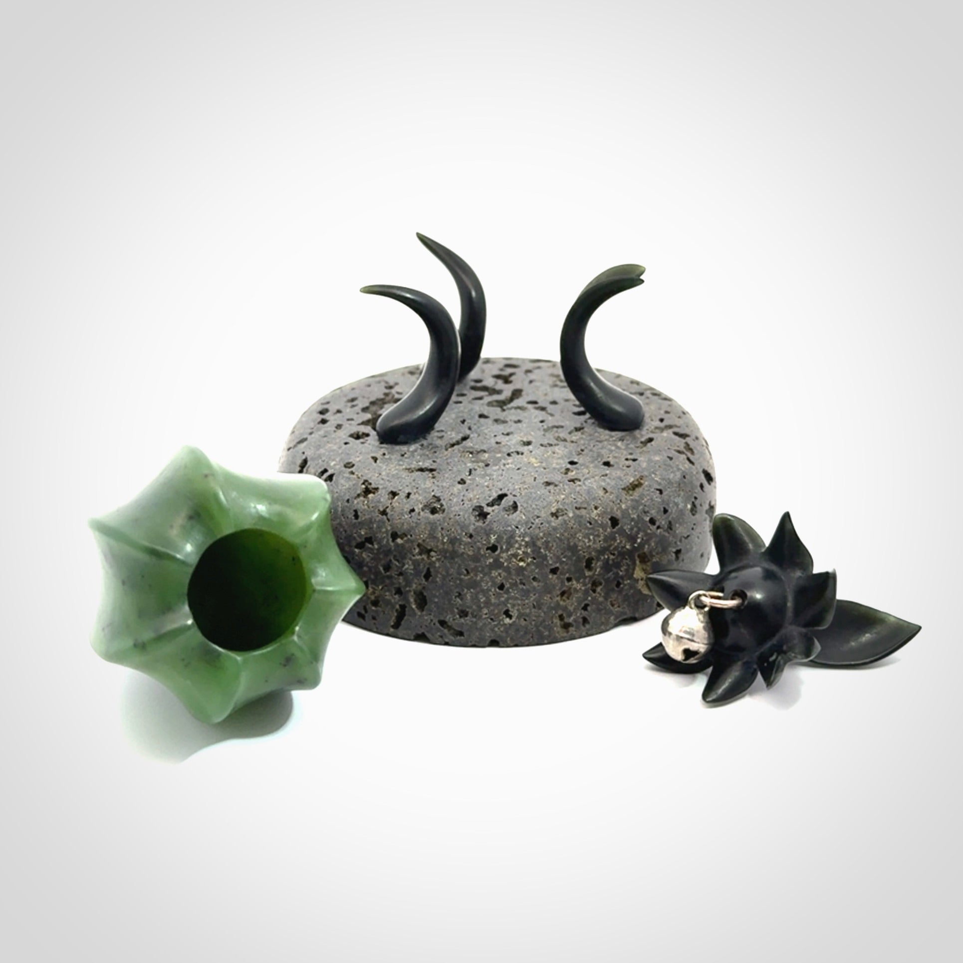 Hand carved Gooseberry sculpture crafted in Black Jade, British Columbian Jade with Basalt stone stand. One only Gooseberry sculpture with lid that encloses a bell.