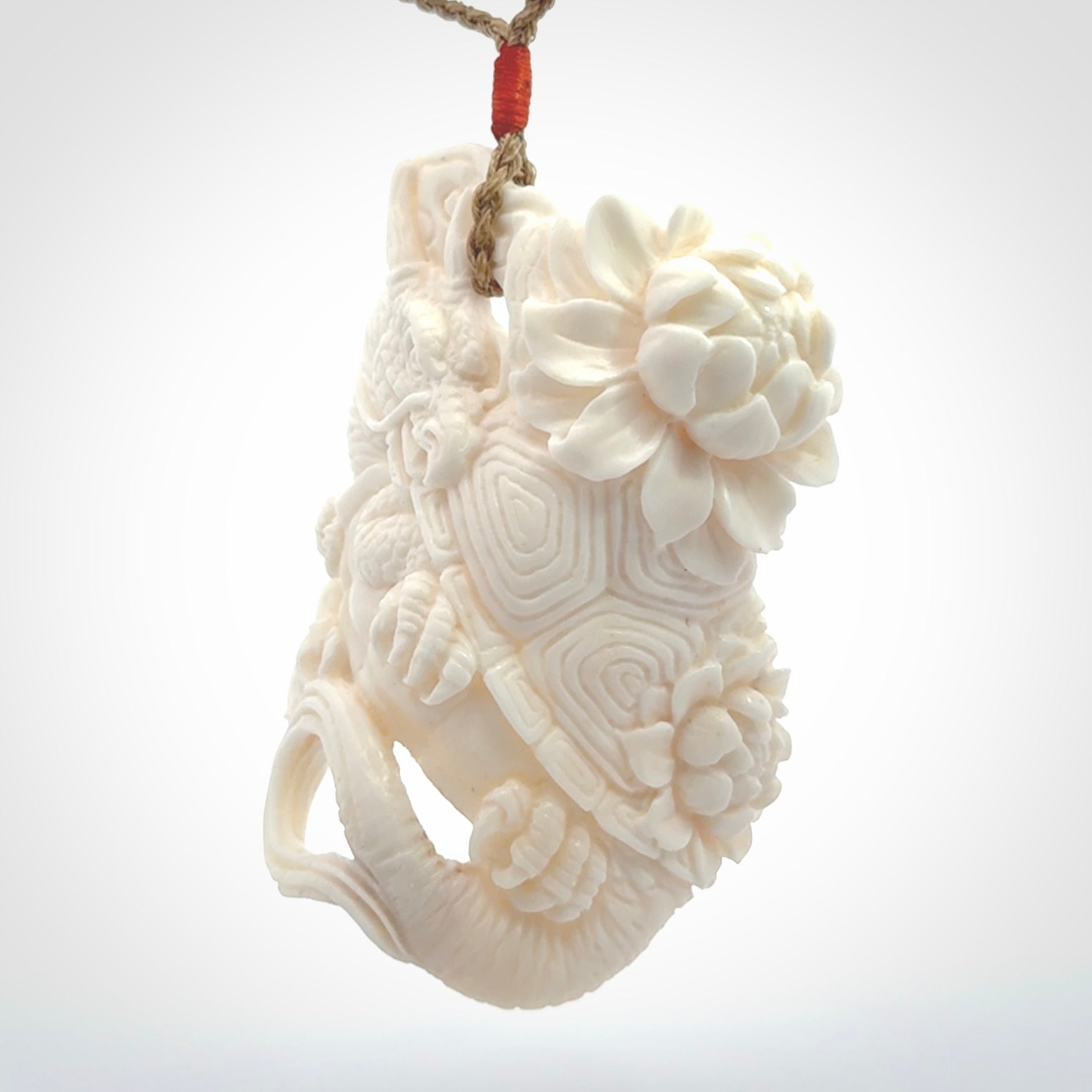 This is a hand carved bone baby dragon pendant. It is made from bone and has an adjustable tan coloured cord. This is a large sized necklace and is a very unique, one only, pendant that is a piece for art lovers.