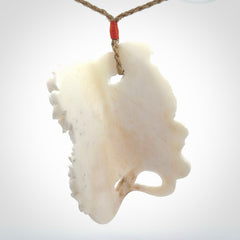 This is a hand carved bone baby dragon pendant. It is made from bone and has an adjustable tan coloured cord. This is a large sized necklace and is a very unique, one only, pendant that is a piece for art lovers.