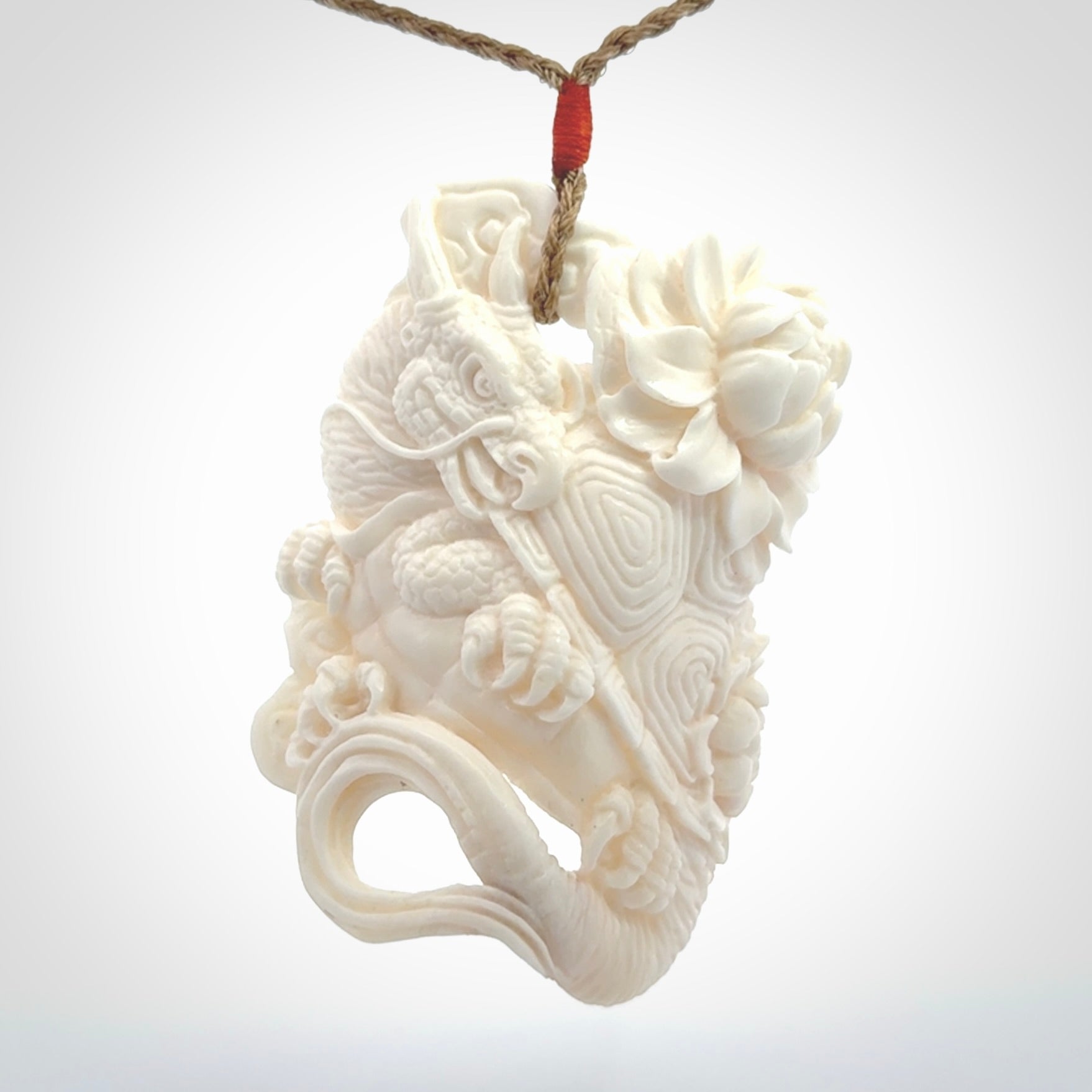 This is a hand carved bone baby dragon pendant. It is made from bone and has an adjustable tan coloured cord. This is a large sized necklace and is a very unique, one only, pendant that is a piece for art lovers.