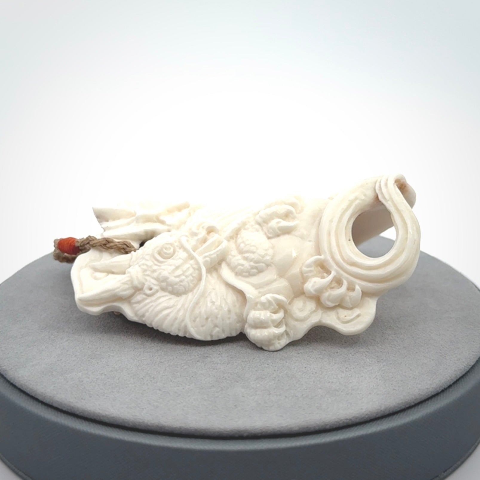 This is a hand carved bone baby dragon pendant. It is made from bone and has an adjustable tan coloured cord. This is a large sized necklace and is a very unique, one only, pendant that is a piece for art lovers.