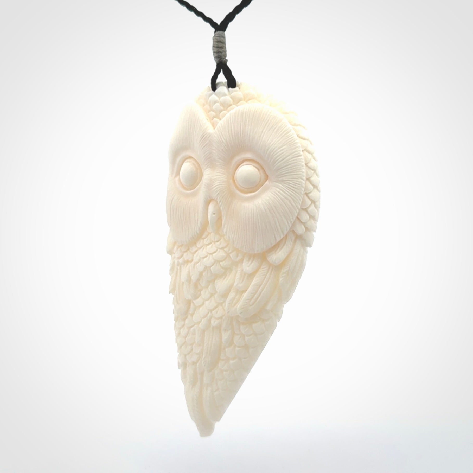 A Owl design carving, hand made for us from Bone. This pendant is provided with an adjustable black cord.