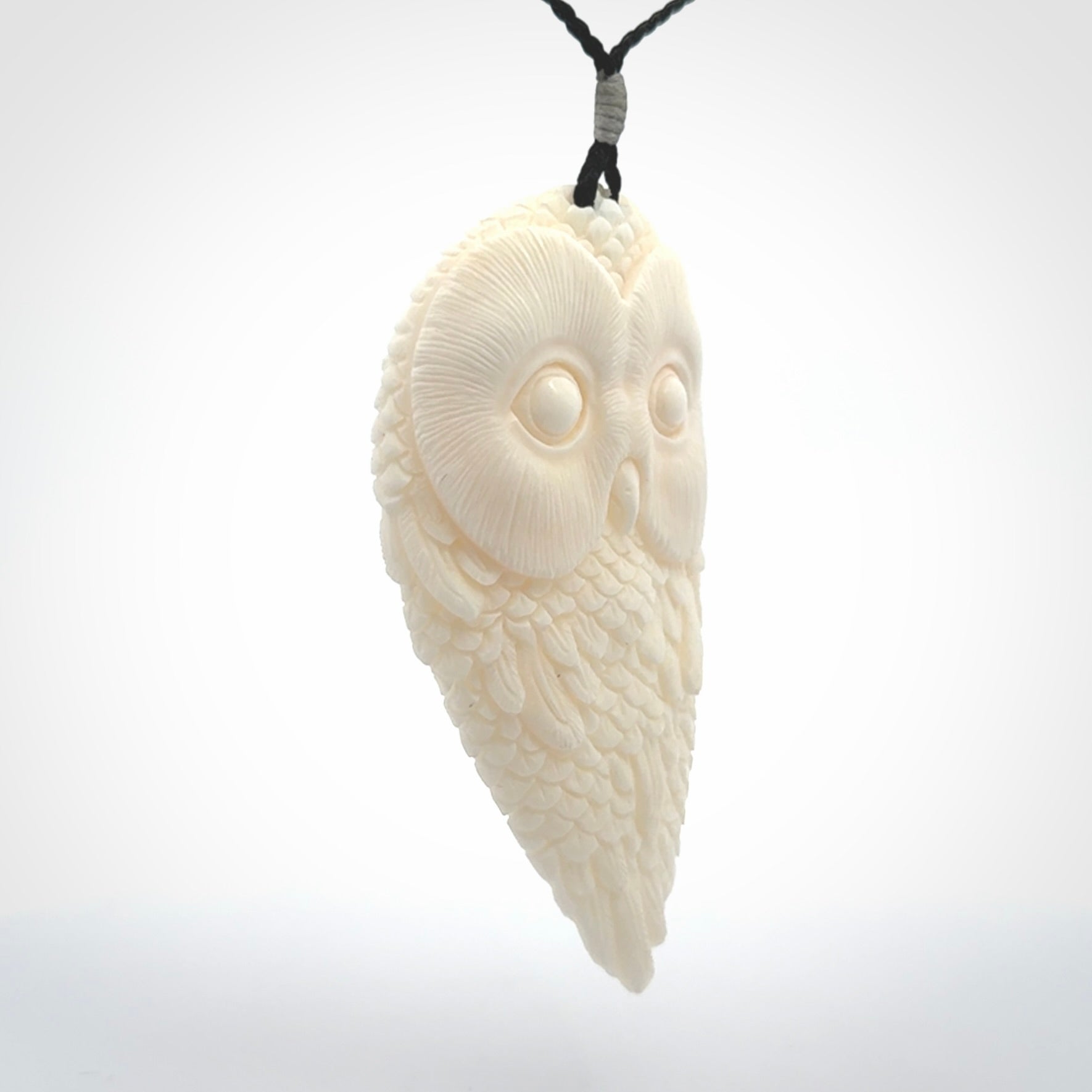 A Owl design carving, hand made for us from Bone. This pendant is provided with an adjustable black cord.