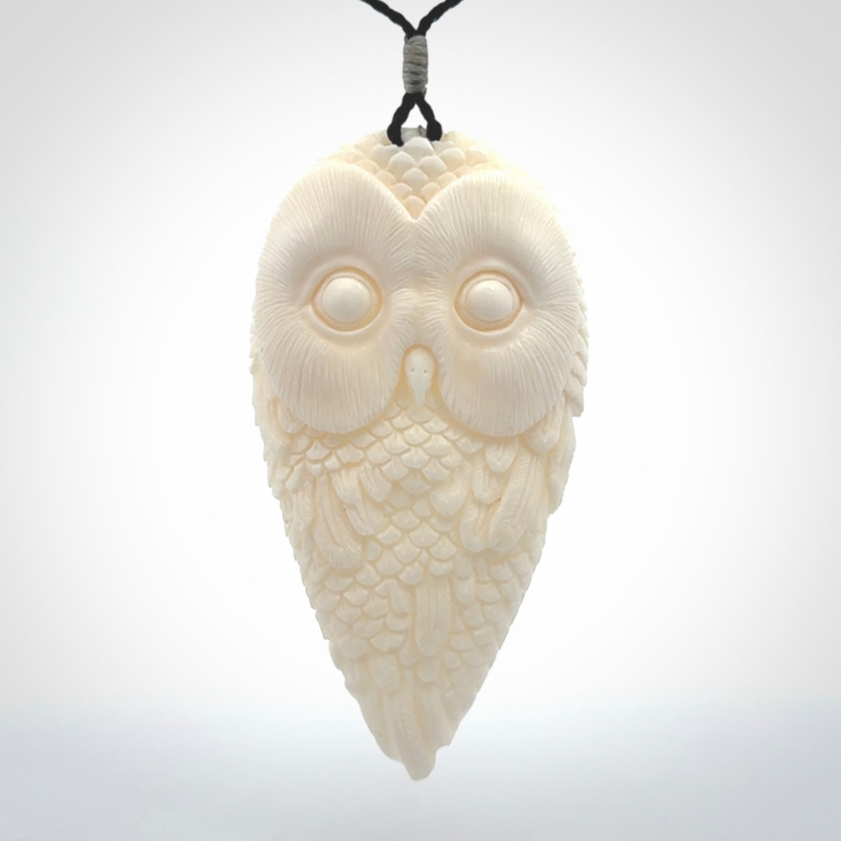 A Owl design carving, hand made for us from Bone. This pendant is provided with an adjustable black cord.