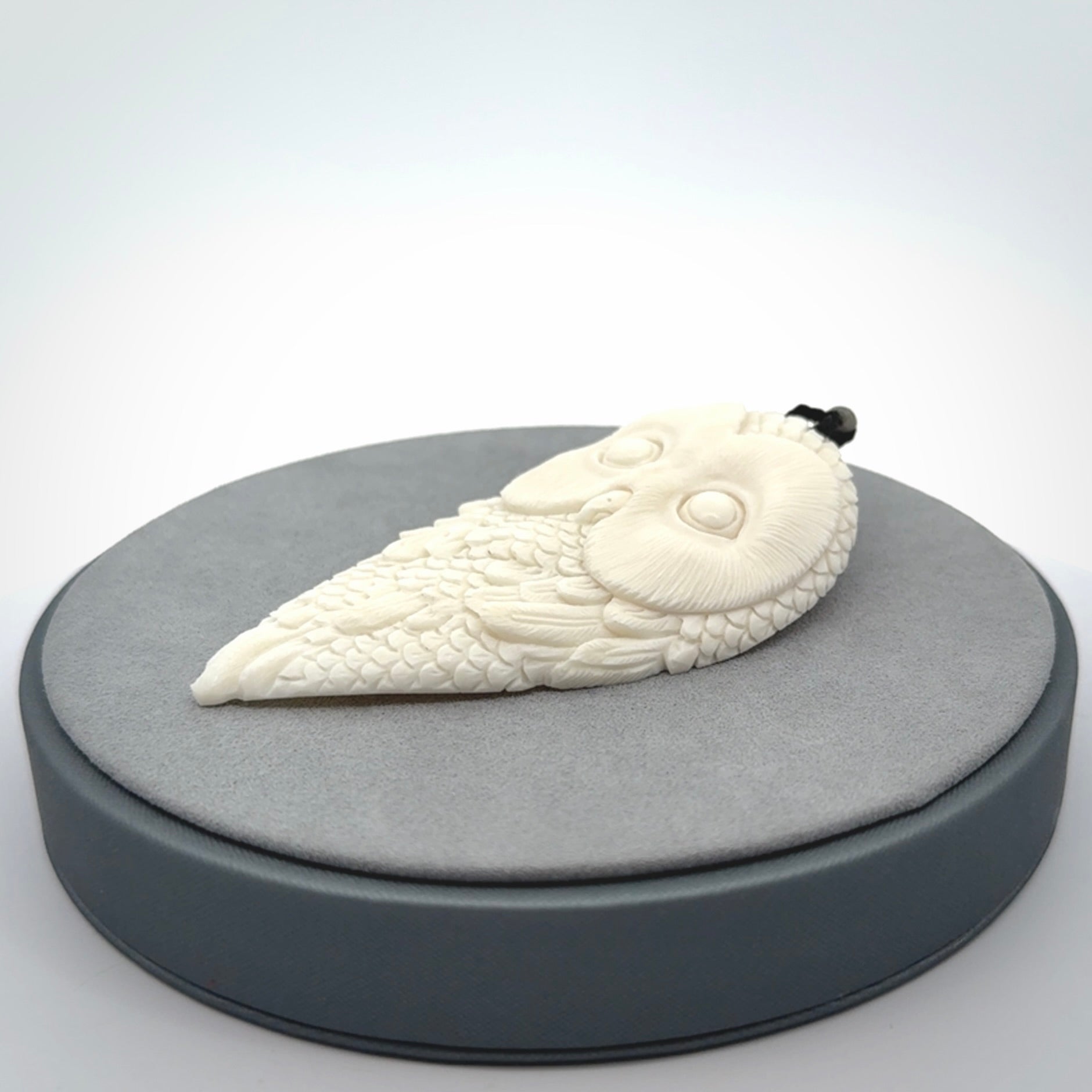 A Owl design carving, hand made for us from Bone. This pendant is provided with an adjustable black cord.