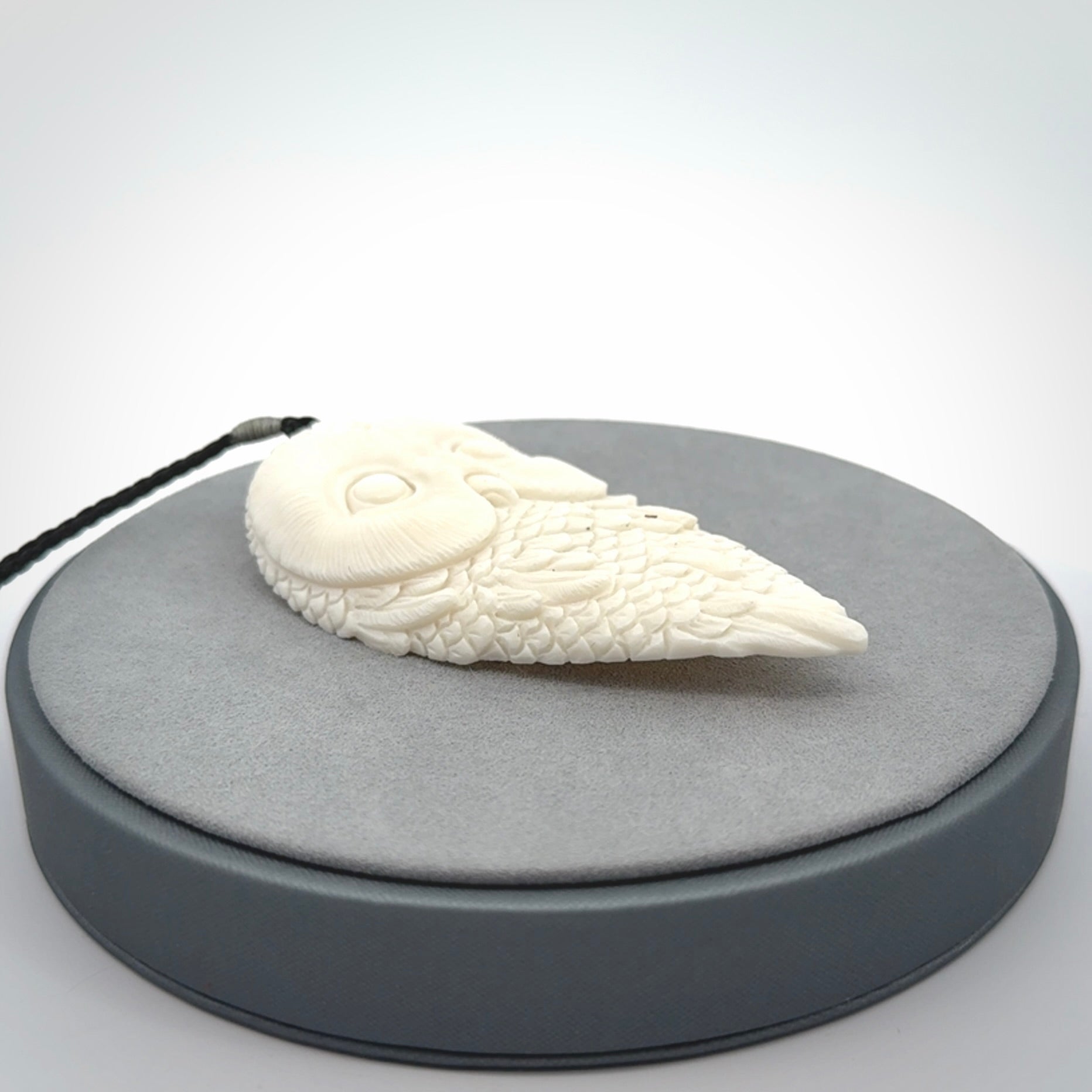 A Owl design carving, hand made for us from Bone. This pendant is provided with an adjustable black cord.