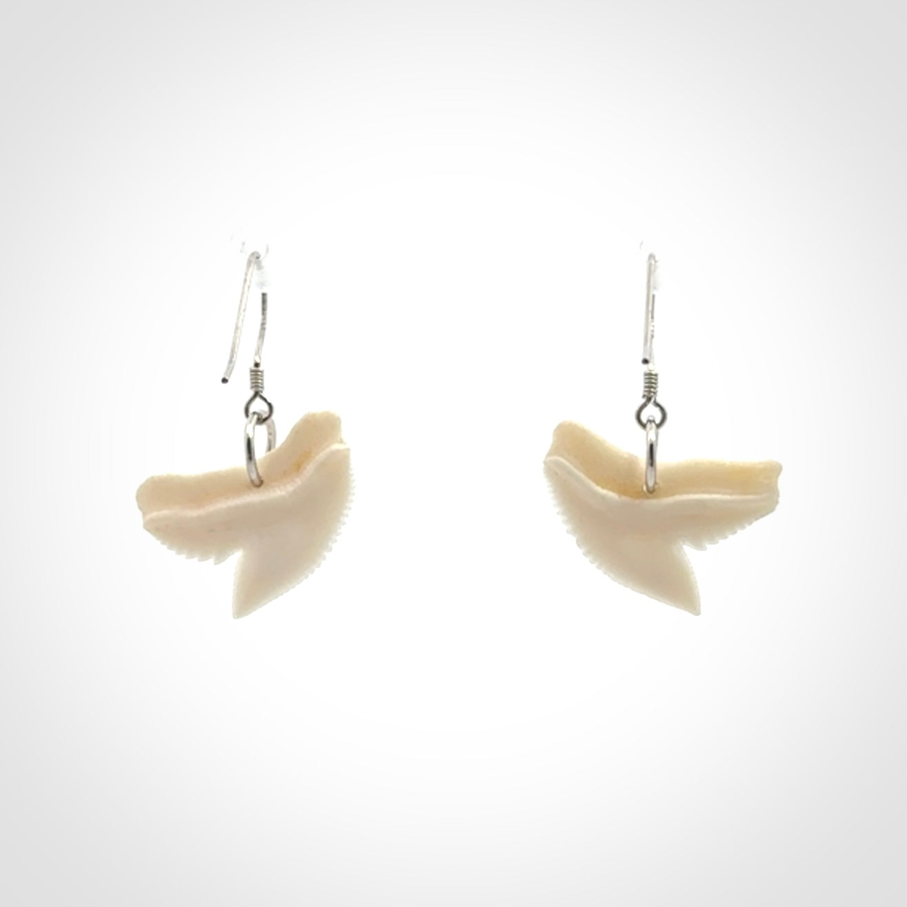 Hand carved small sized Tiger shark tooth earrings. Hand made shark tooth earrings. Real shark tooth art to wear. Free Shipping worldwide. Packaged in a woven kete pouch.