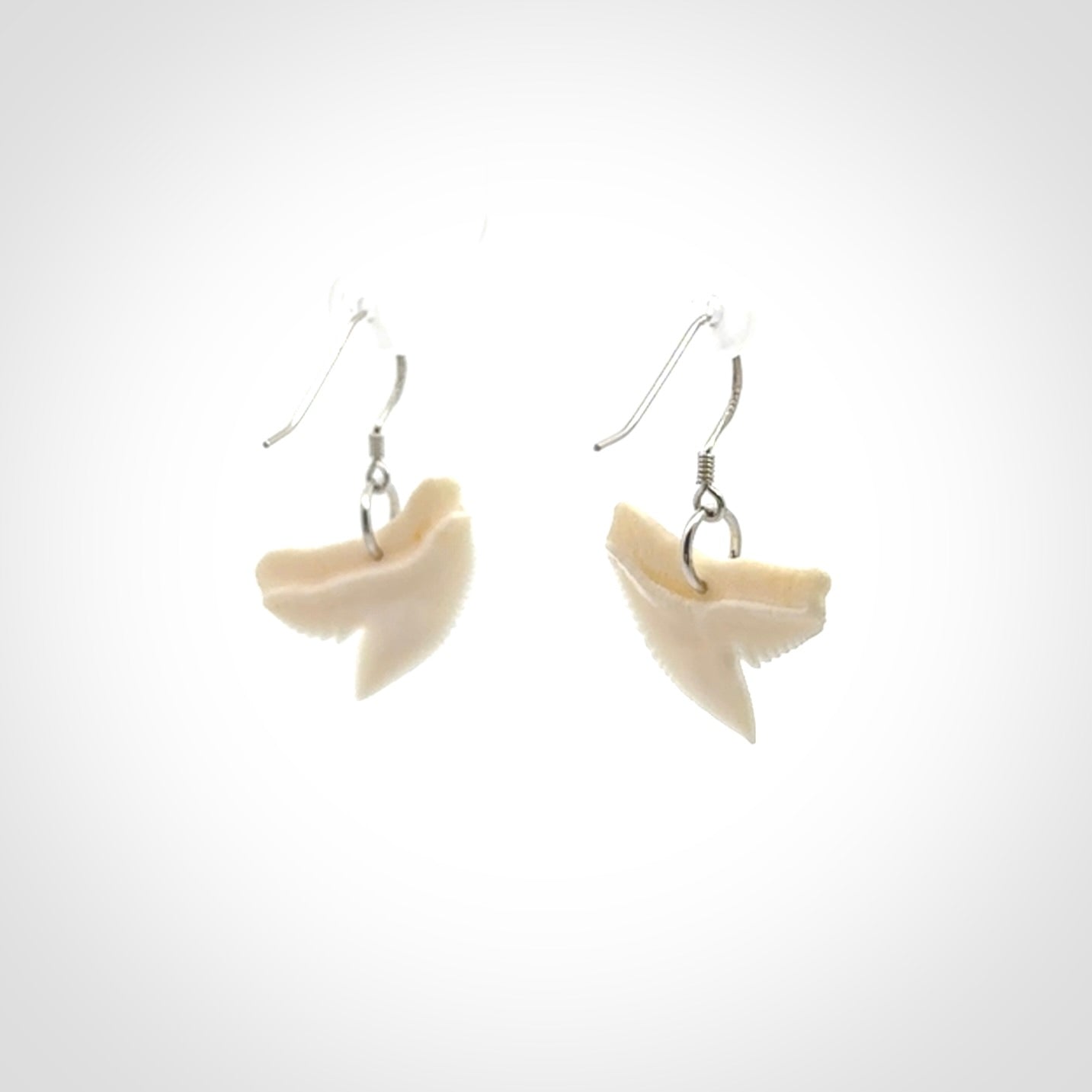 Hand carved small sized Tiger shark tooth earrings. Hand made shark tooth earrings. Real shark tooth art to wear. Free Shipping worldwide. Packaged in a woven kete pouch.