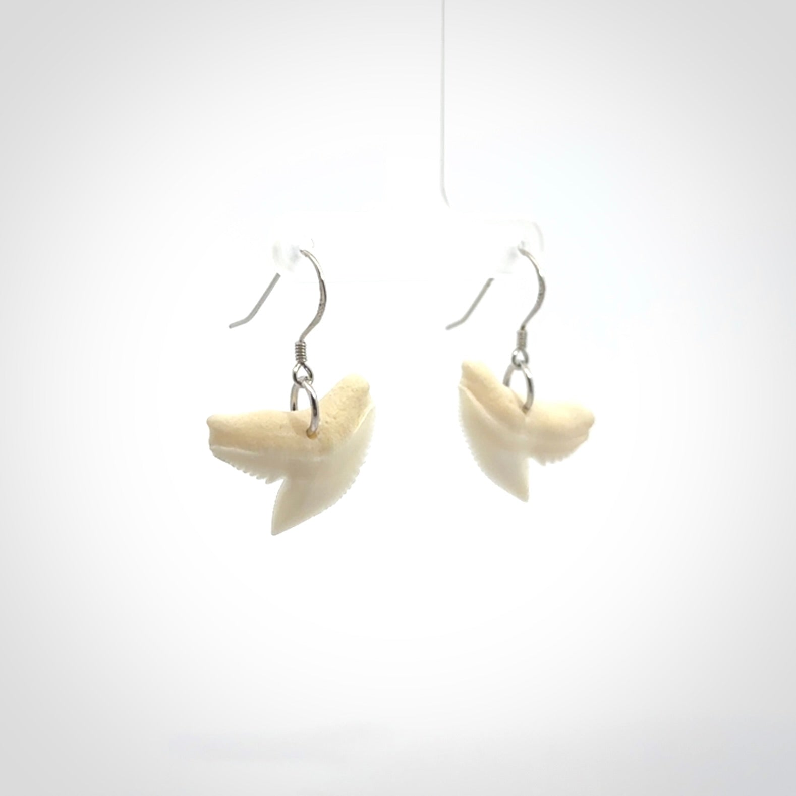 Hand carved small sized Tiger shark tooth earrings. Hand made shark tooth earrings. Real shark tooth art to wear. Free Shipping worldwide. Packaged in a woven kete pouch.