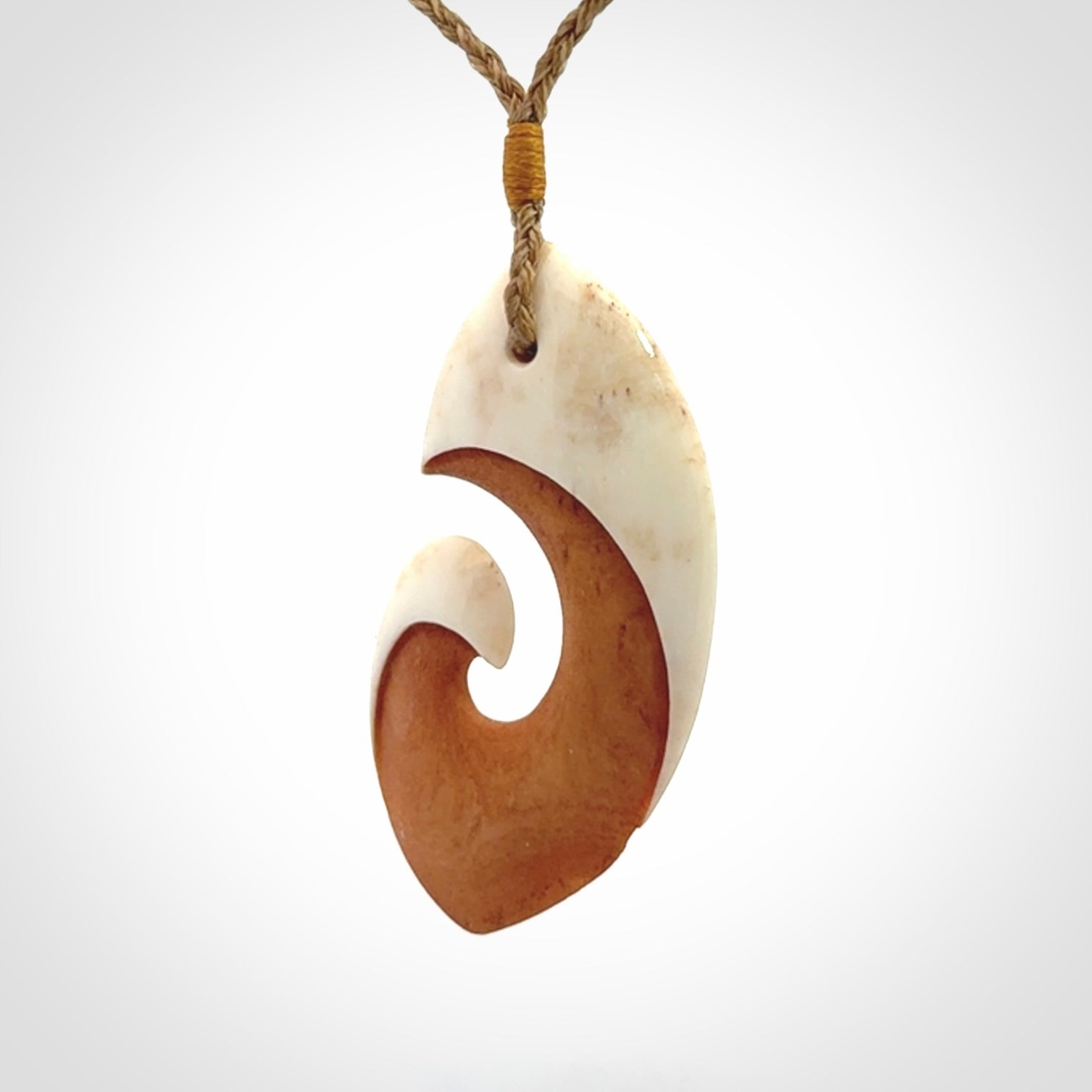 Hand carved bone koru pendant