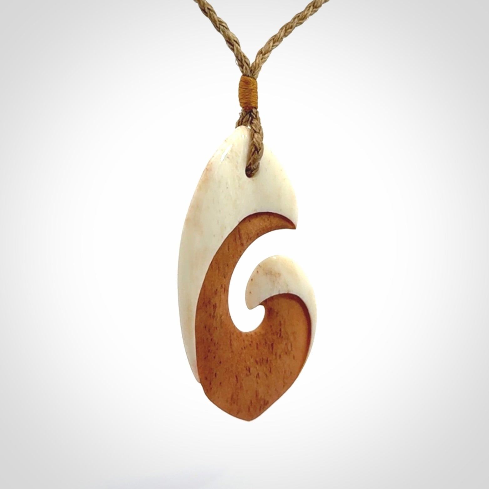 Hand carved bone hook pendant