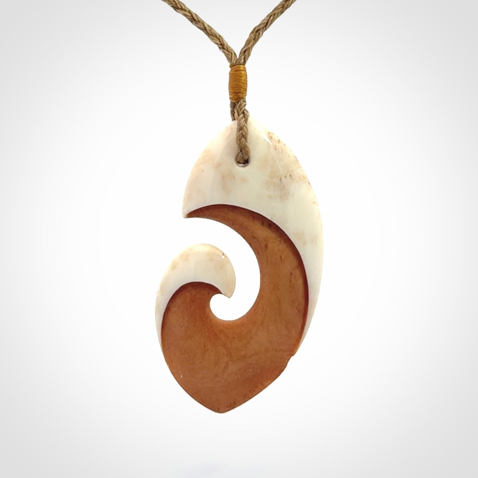 Hand carved bone hook pendant