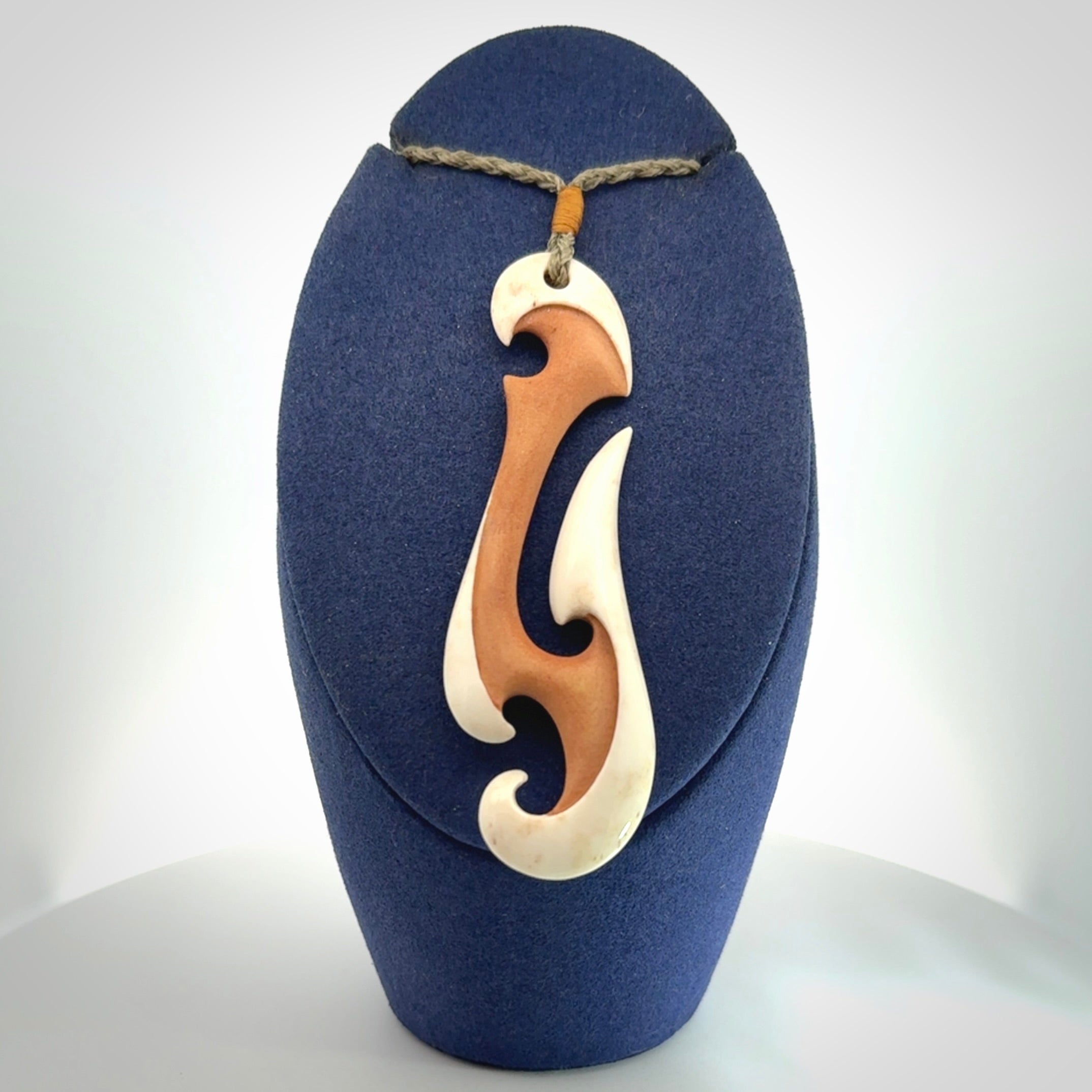 Hand carved bone hook pendant