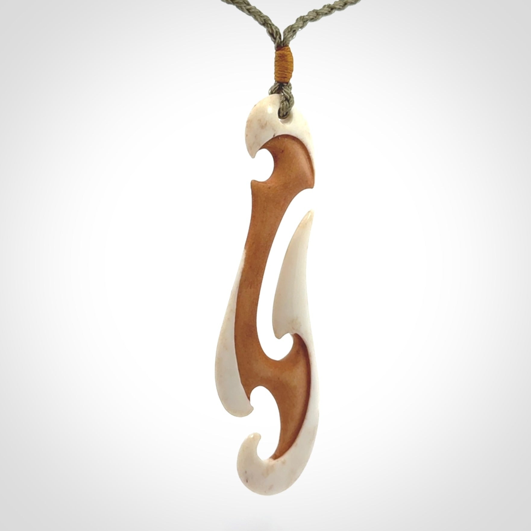 Hand carved bone hook pendant