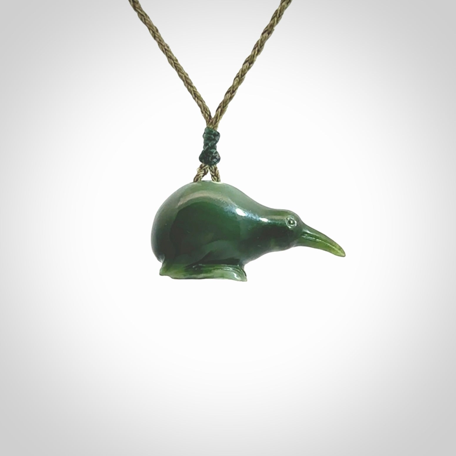 Hand carved Jade kiwi pendant for lovers of birds. Hand made kiwi necklace with black adjustable cord. Unique gifts and Art to Wear by NZ Pacific.