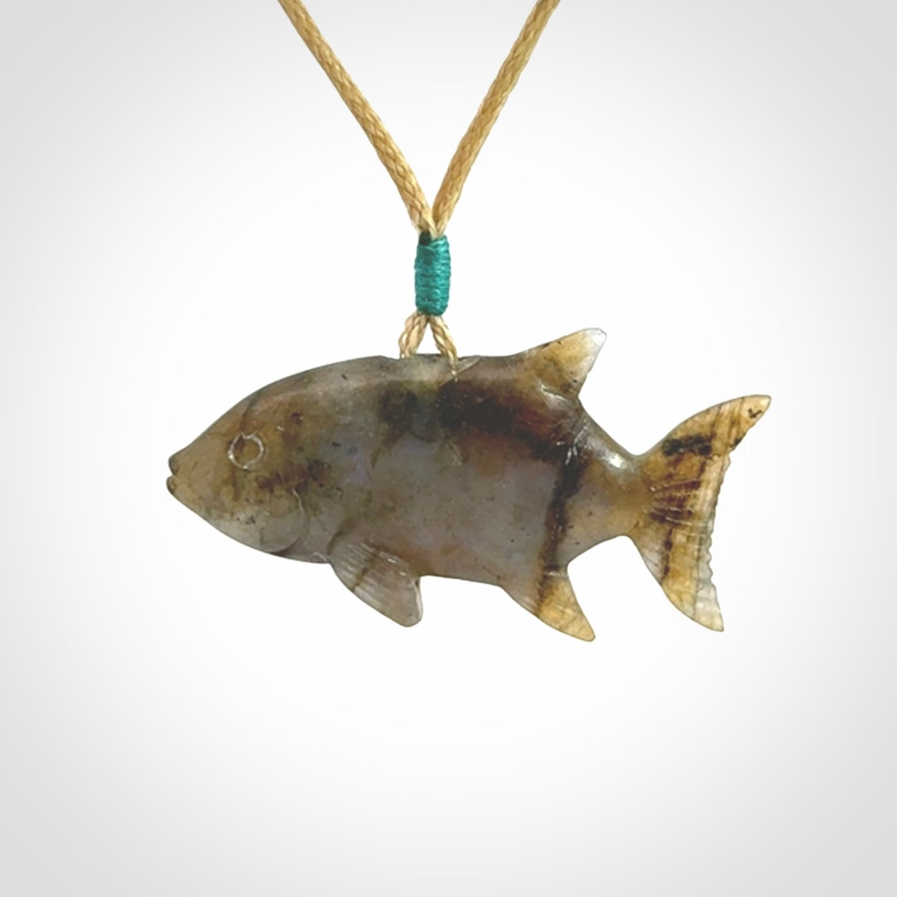 Hand carved Labradorite Trevally fish pendants.