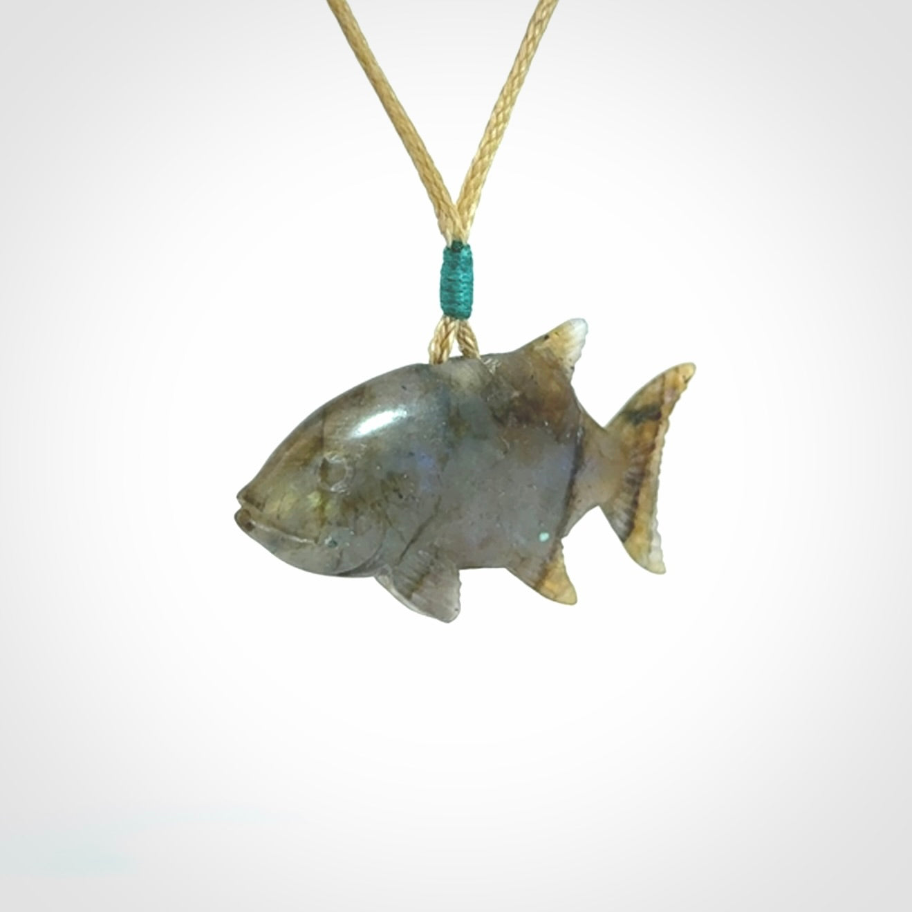 Hand carved Labradorite Trevally fish pendants.