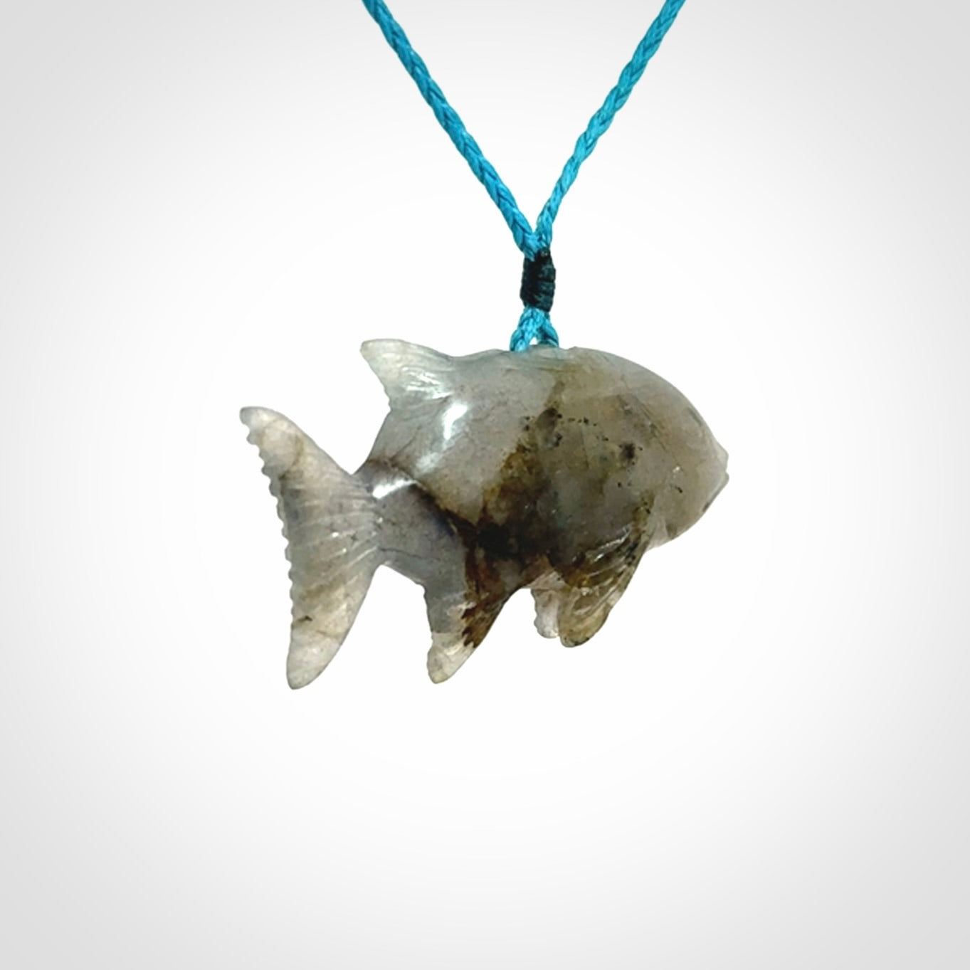 Hand carved Labradorite Trevally fish pendants.