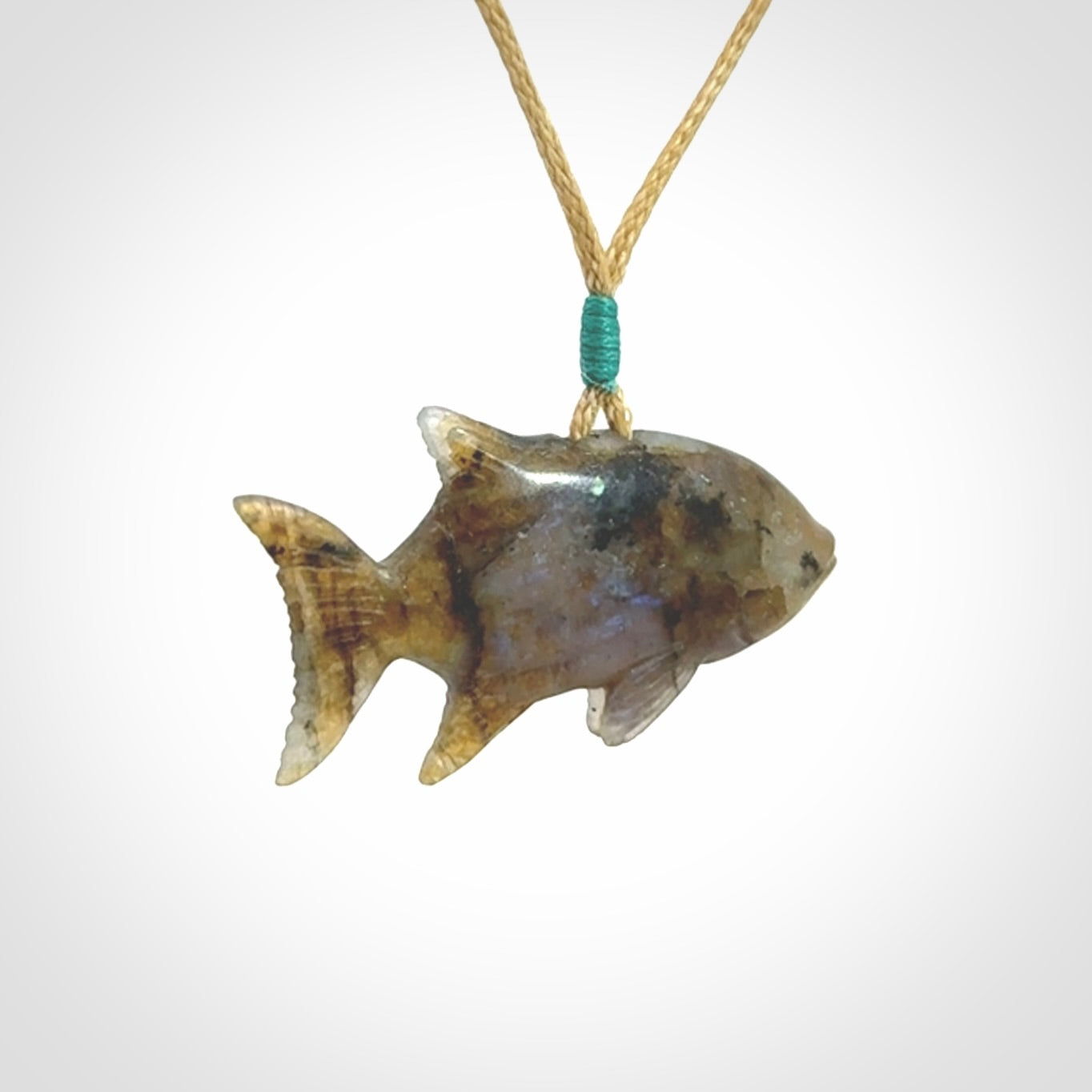 Hand carved Labradorite Trevally fish pendants.
