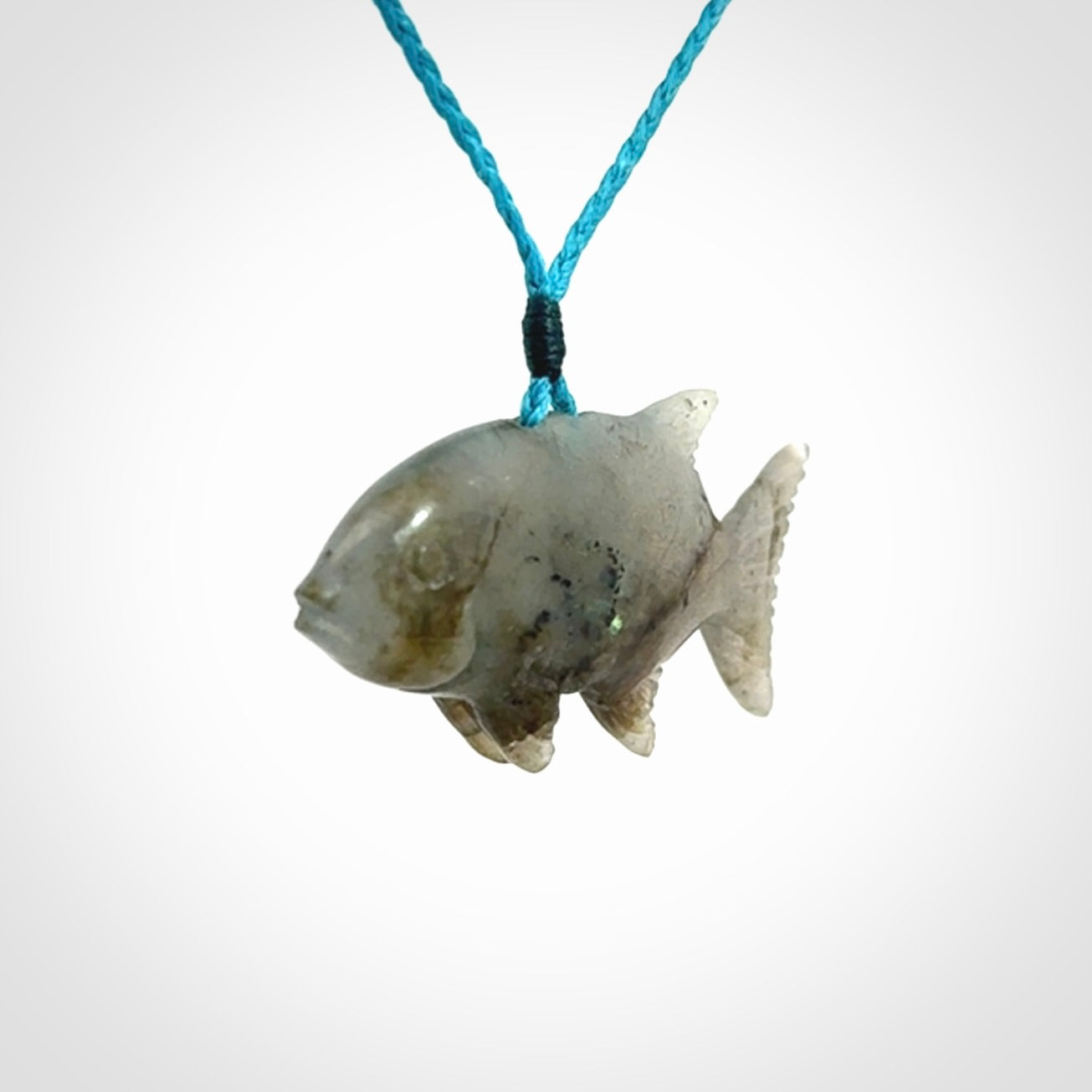 Hand carved Labradorite Trevally fish pendants.