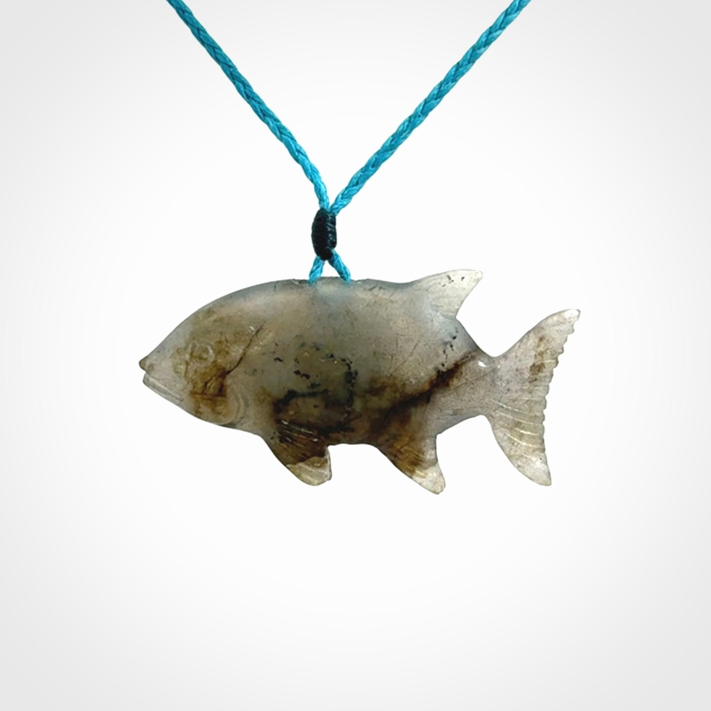 Hand carved Labradorite Trevally fish pendants.