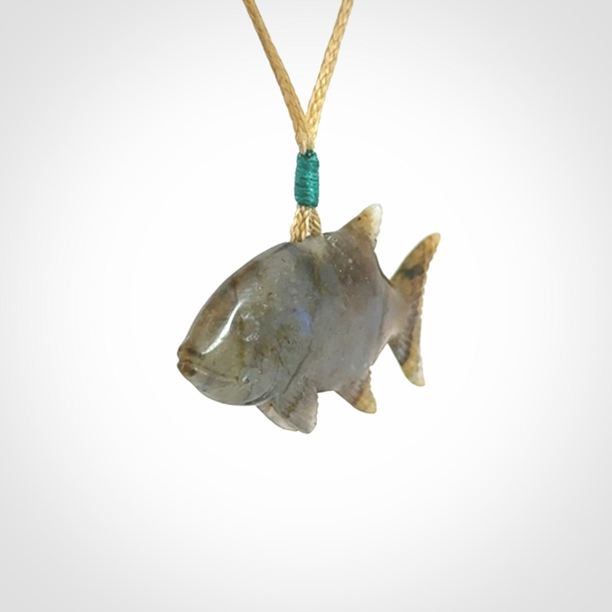 Hand carved Labradorite Trevally fish pendants.