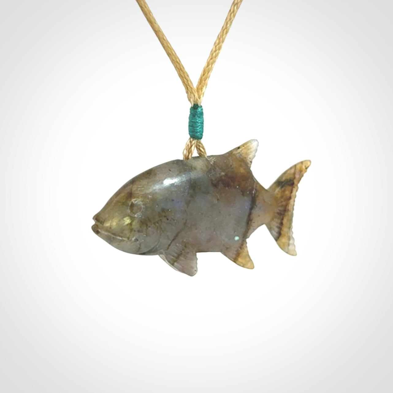 Hand carved Labradorite Trevally fish pendants.