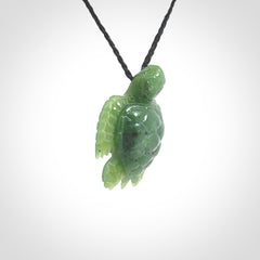 British Columbian jade turtle pendant. Hand carved jade turtle pendant, made by NZ Pacific for sale online. Unique handmade jewellery. Provided with an adjustable cord and packaged in a woven kete pouch.