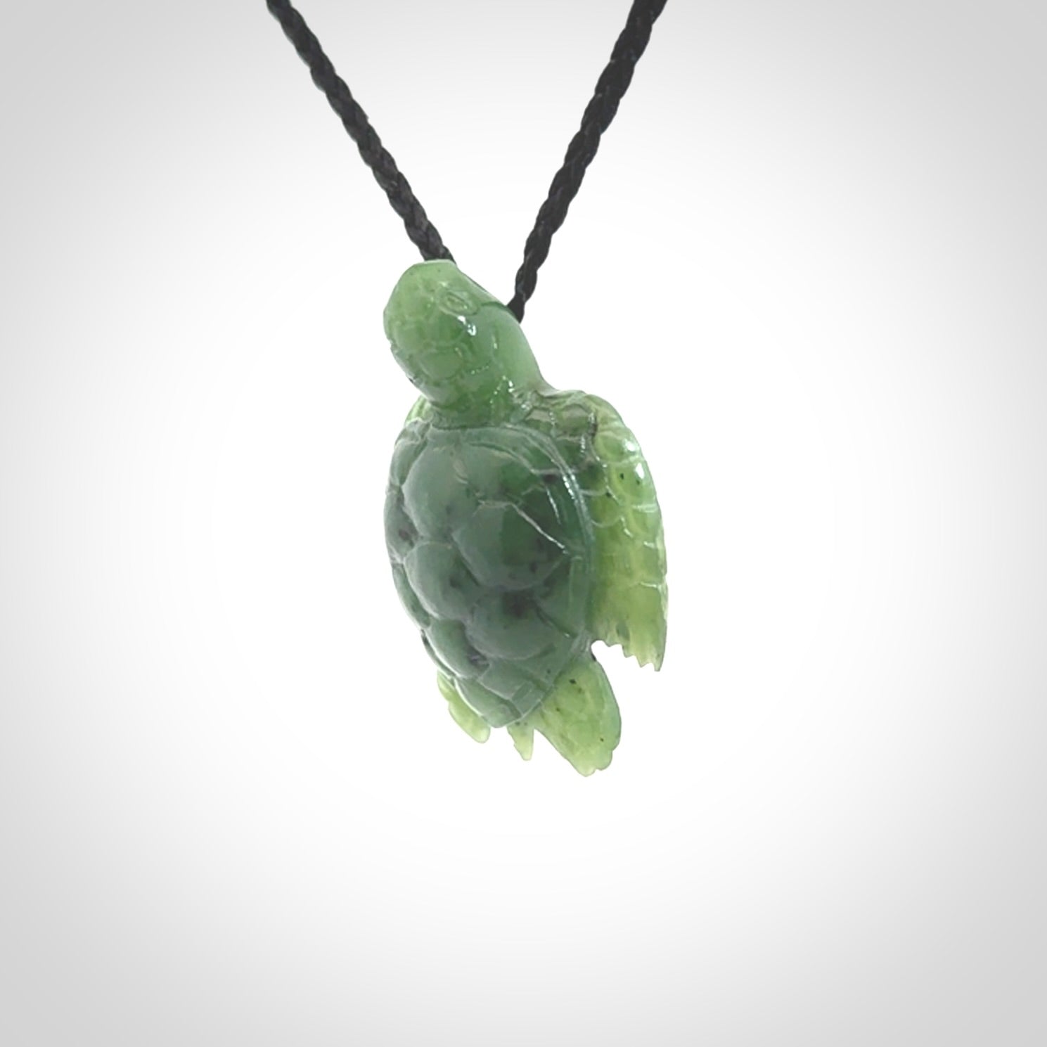 British Columbian jade turtle pendant. Hand carved jade turtle pendant, made by NZ Pacific for sale online. Unique handmade jewellery. Provided with an adjustable cord and packaged in a woven kete pouch.