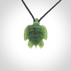 British Columbian jade turtle pendant. Hand carved jade turtle pendant, made by NZ Pacific for sale online. Unique handmade jewellery. Provided with an adjustable cord and packaged in a woven kete pouch.